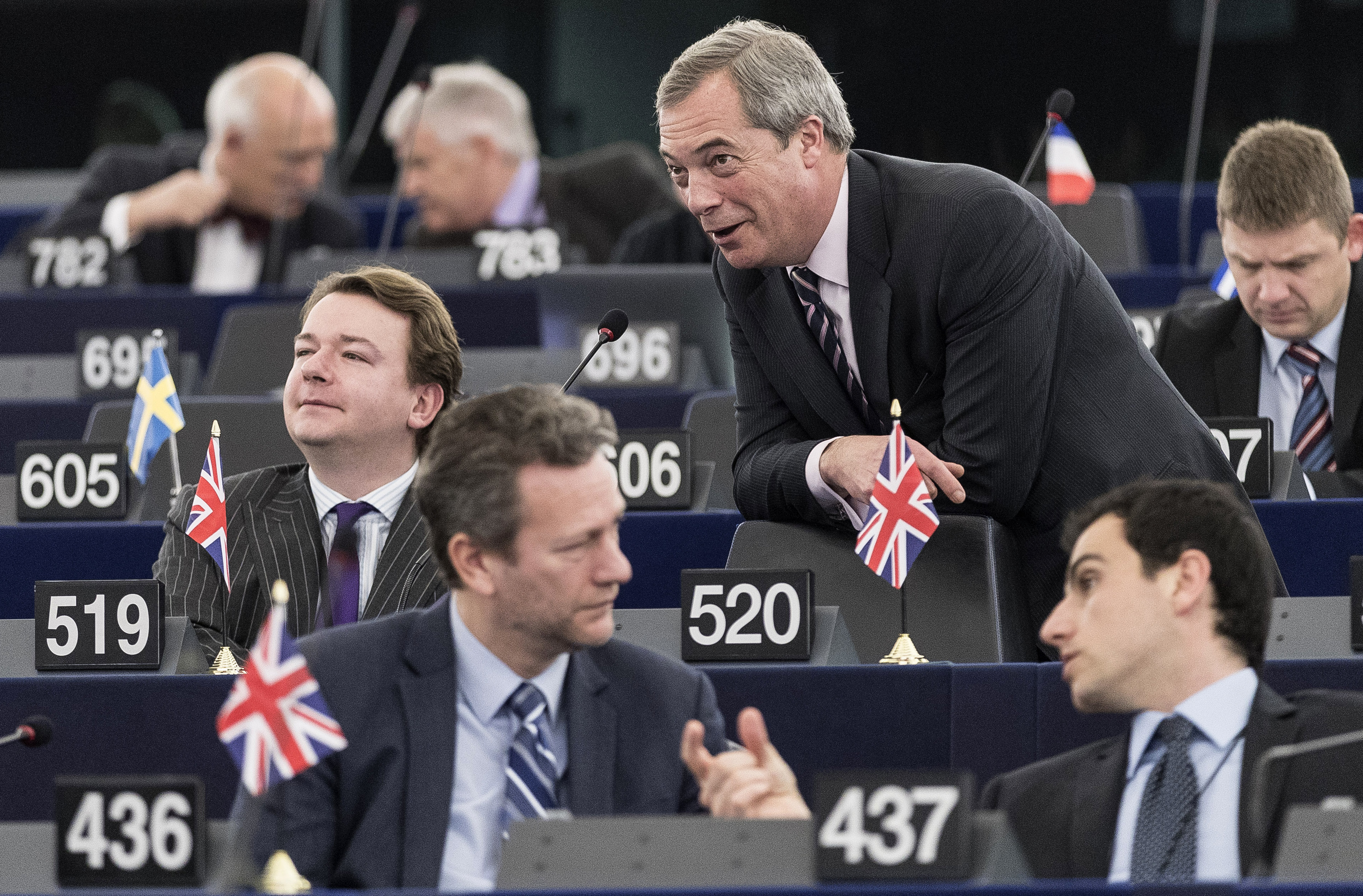 Former UKIP leader Nigel Farage, centre right, talks with British Parliament member Tim Aker, second row left, during a session at the European Parliament in Strasbourg, eastern France, Tuesday, March 14, 2017. CREDIT: AP Photo/Jean-Francois Badias