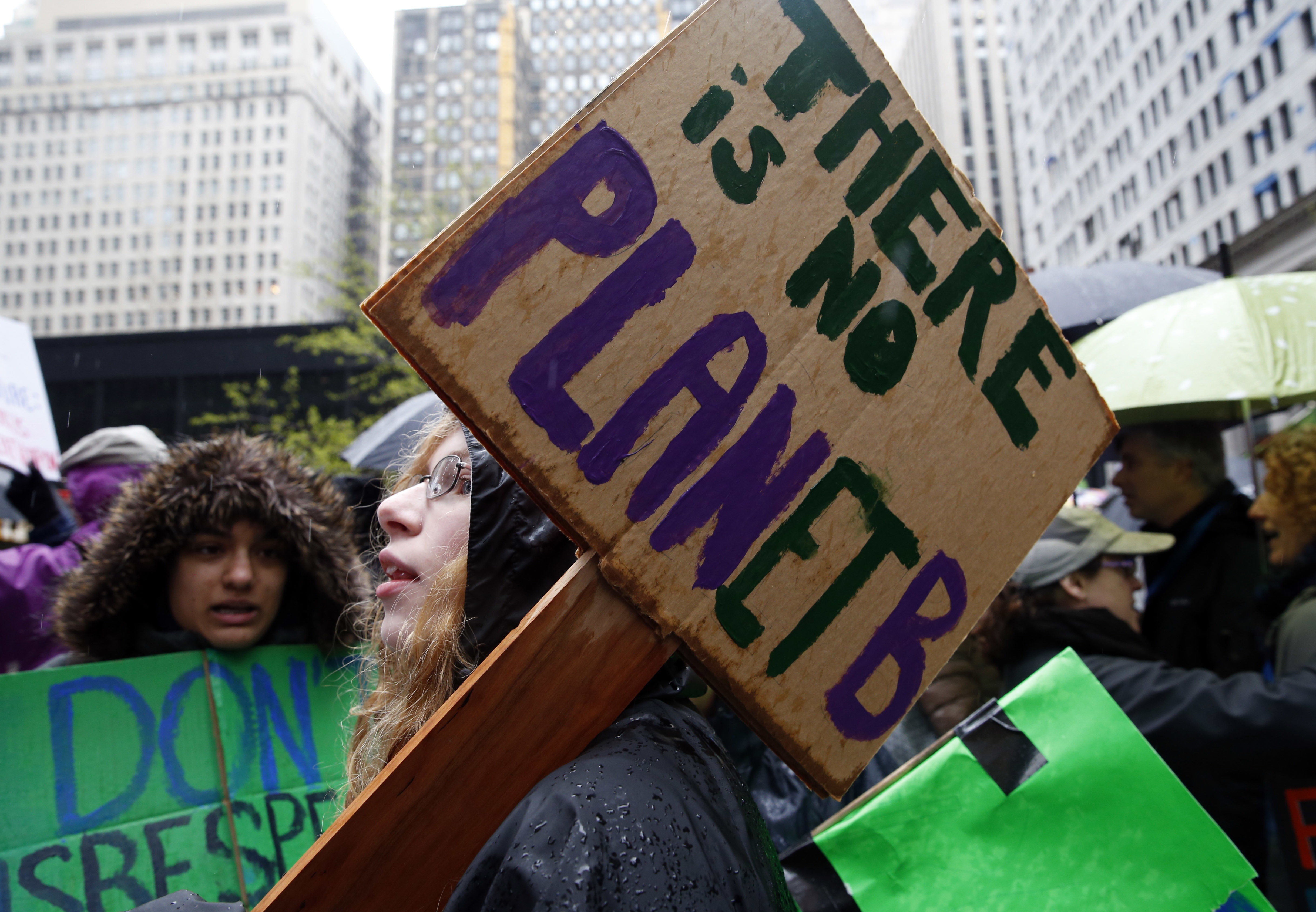 Demonstrators hold signs during a "100 Days of Failure" protest and march, Saturday, April 29, 2016, in Chicago. (AP Photo/Nam Y. Huh)