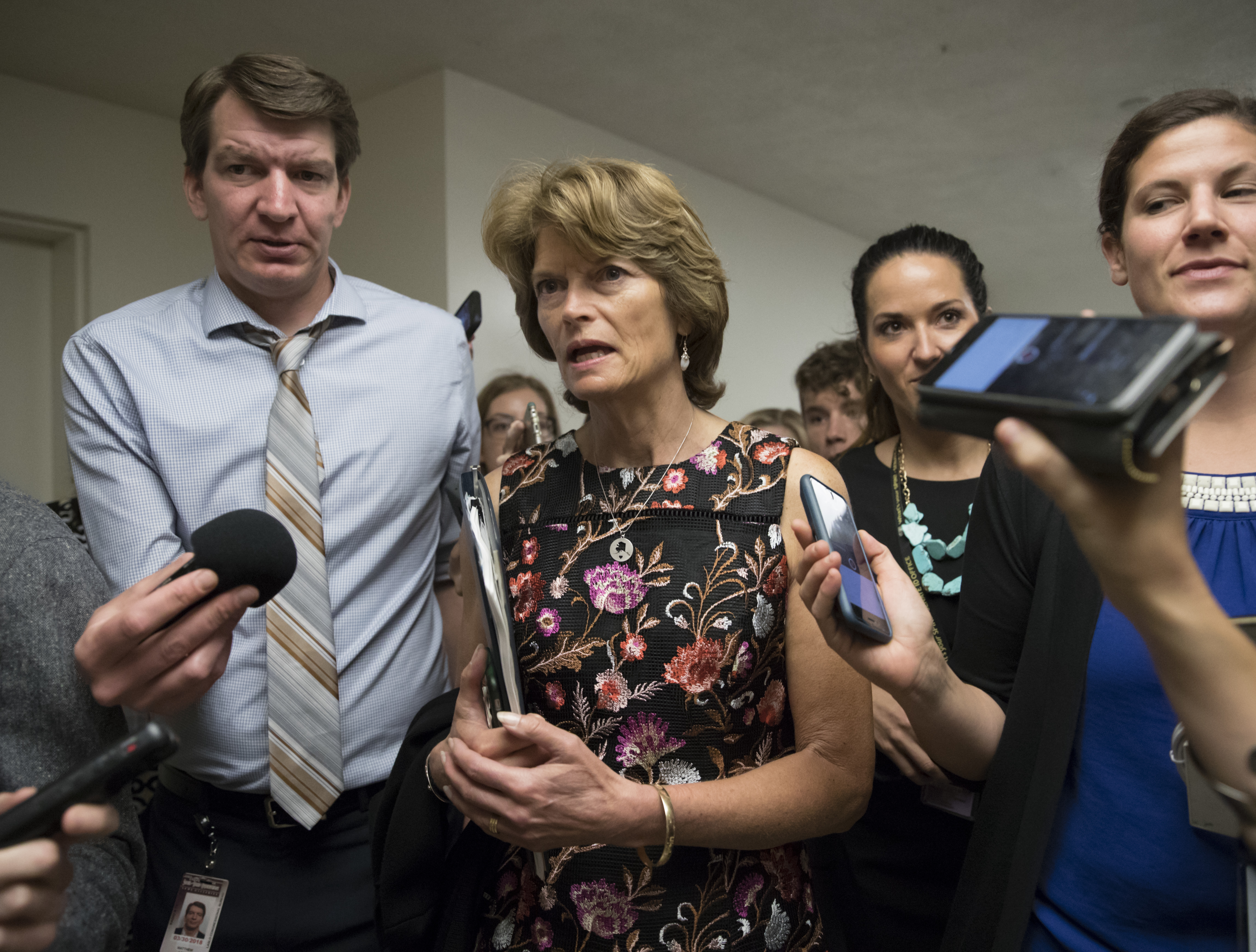 Sen. Lisa Murkowski (R-AK) and other lawmakers, head to the Senate on Capitol Hill in Washington, July 13, 2017. (CREDIT: AP Photo/J. Scott Applewhite)