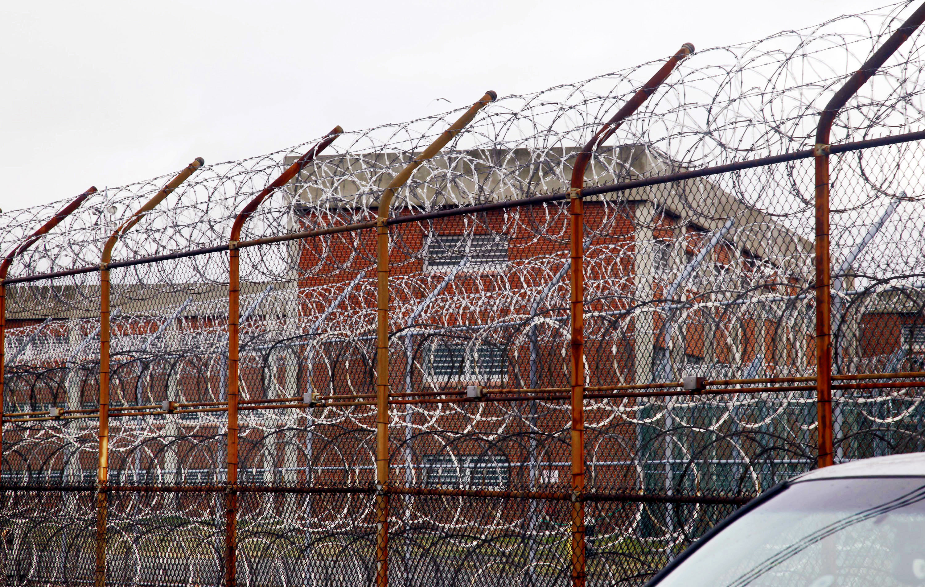 A security fence surrounds the inmate housing on New York's Rikers Island correctional facility in New York. (CREDIT: AP Photo/Bebeto Matthews, File)