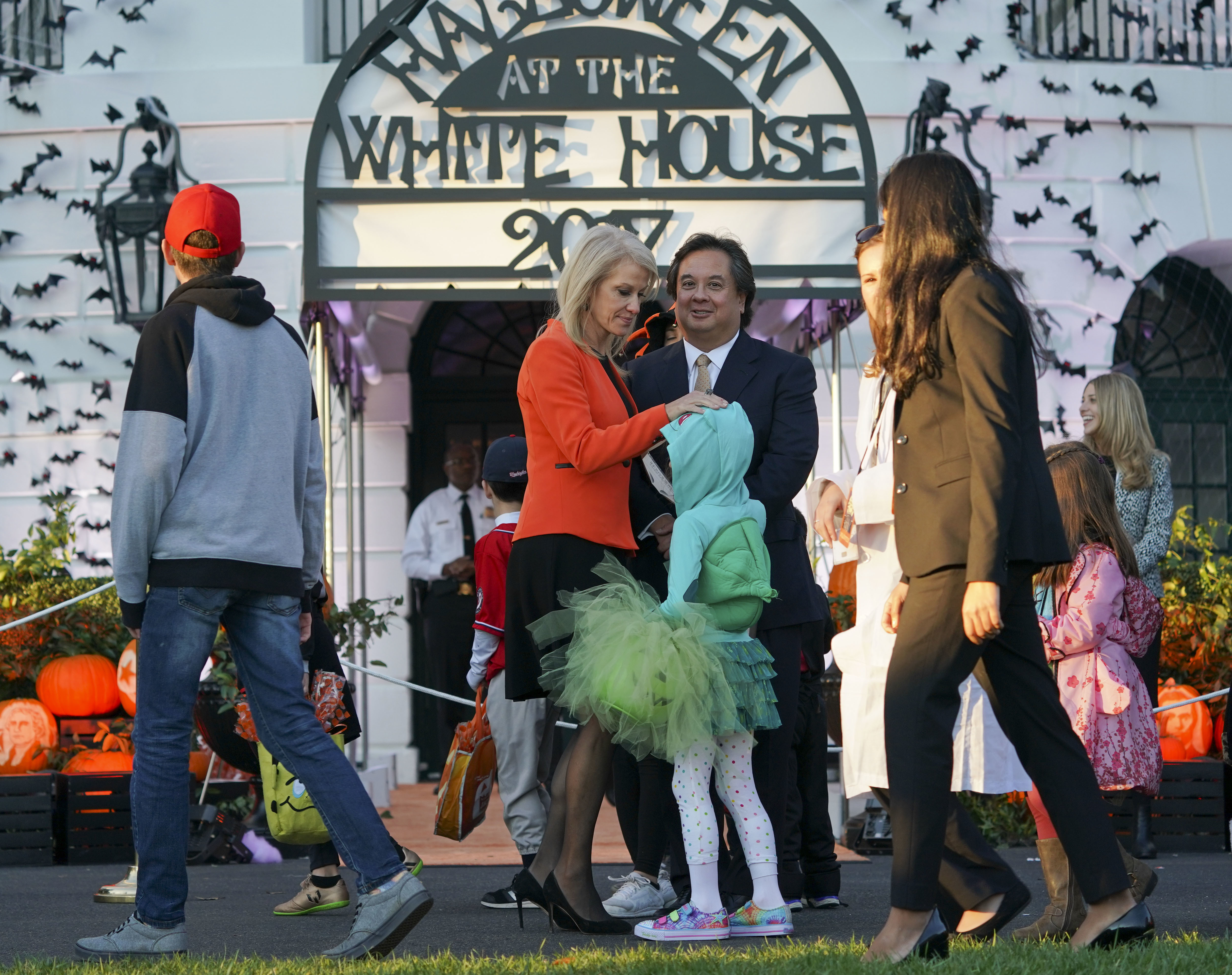 Kellyanne Conway, center, with husband George Conway, right, greet guests on the South Lawn of the White House during a Halloween event. CREDIT: AP Photo/Pablo Martinez Monsivais