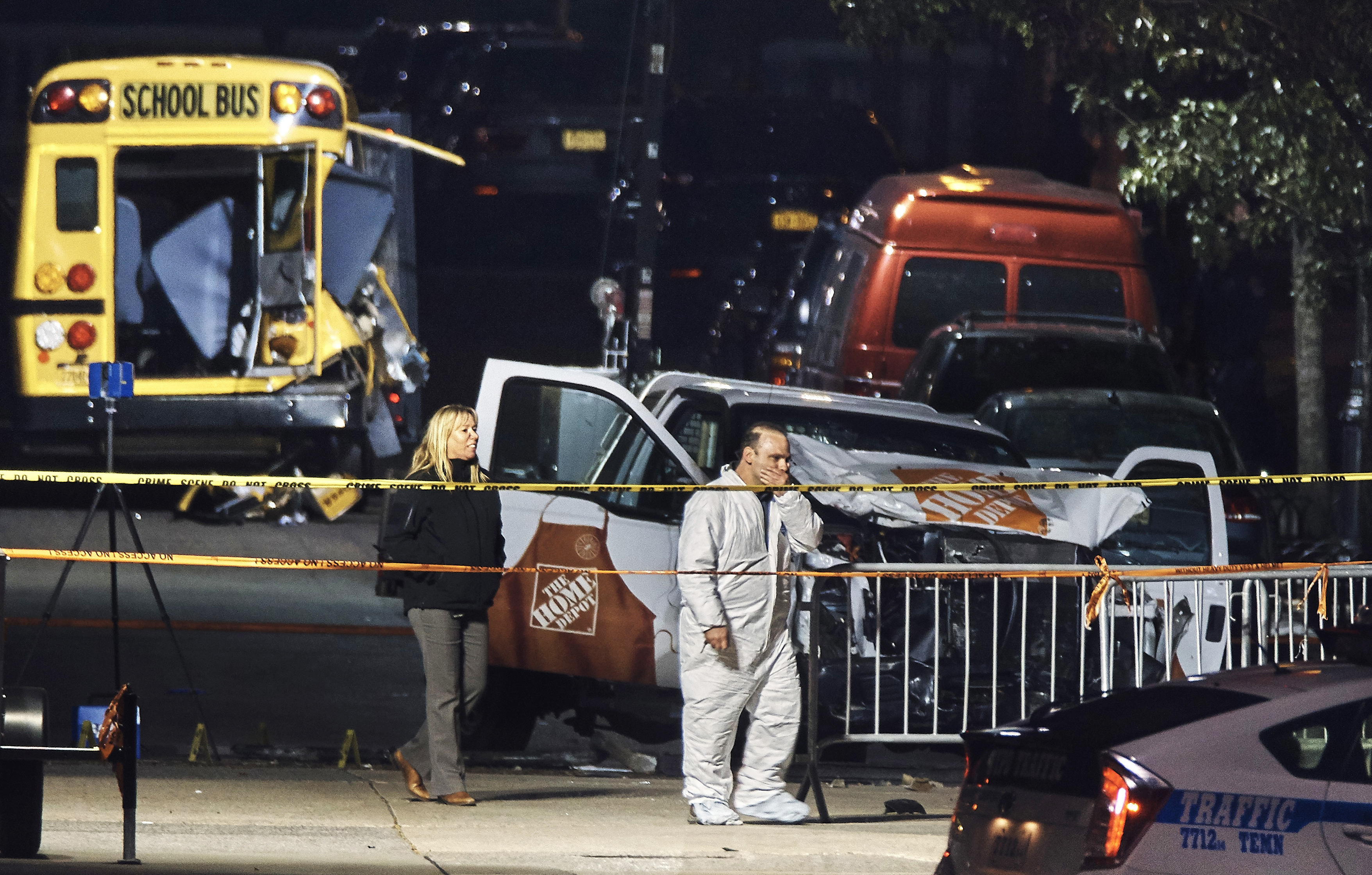 Police work near a damaged Home Depot truck Wednesday, Nov. 1, 2017, after a motorist drove onto a bike path Tuesday near the World Trade Center memorial, striking and killing several people, in New York. (AP Photo/Andres Kudacki)