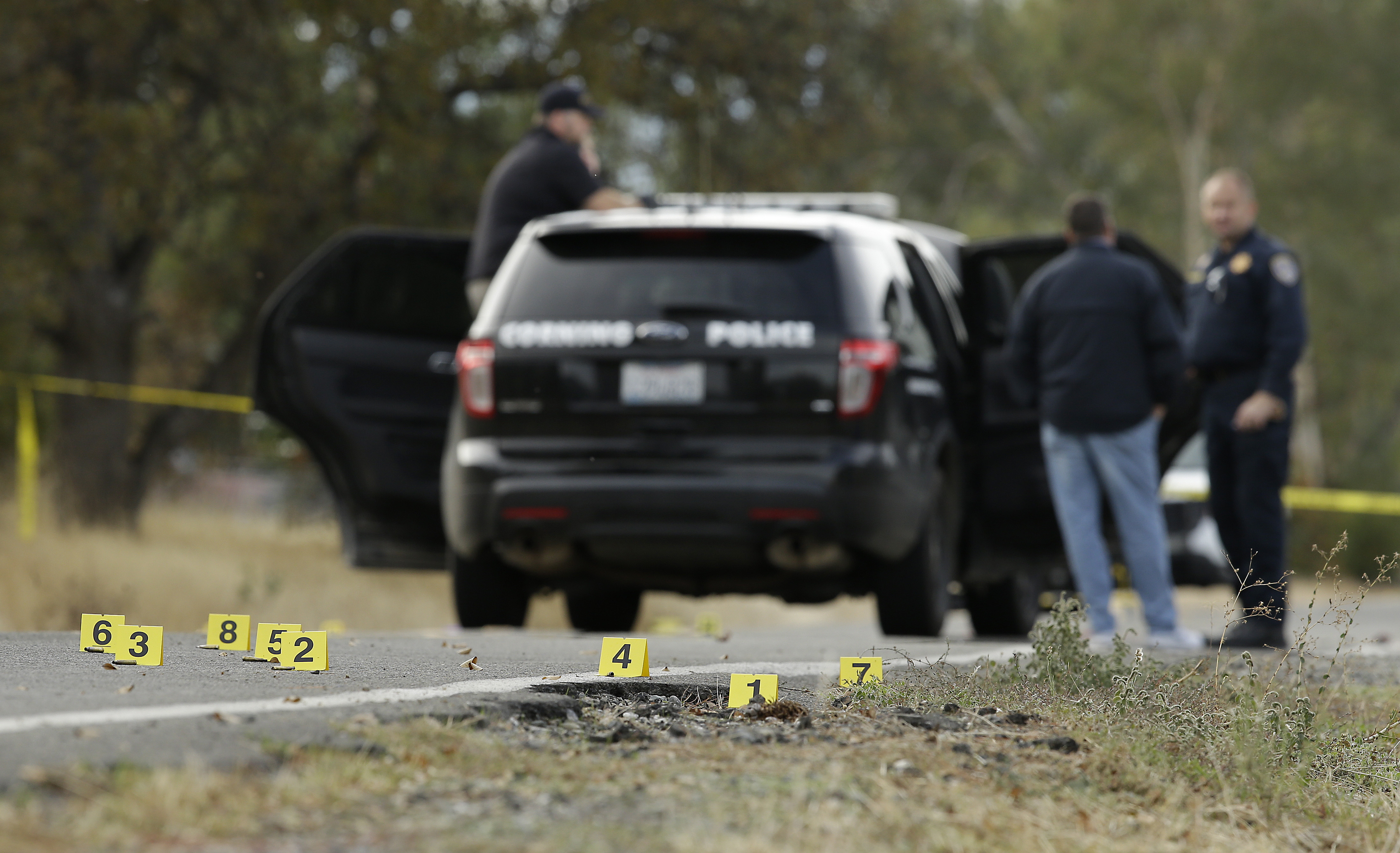 Yellow tags mark where bullet casings found at one of the scenes of a shooting spree at Rancho Tehama Reserve on Tuesday. (CREDIT: AP Photo/Rich Pedroncelli)