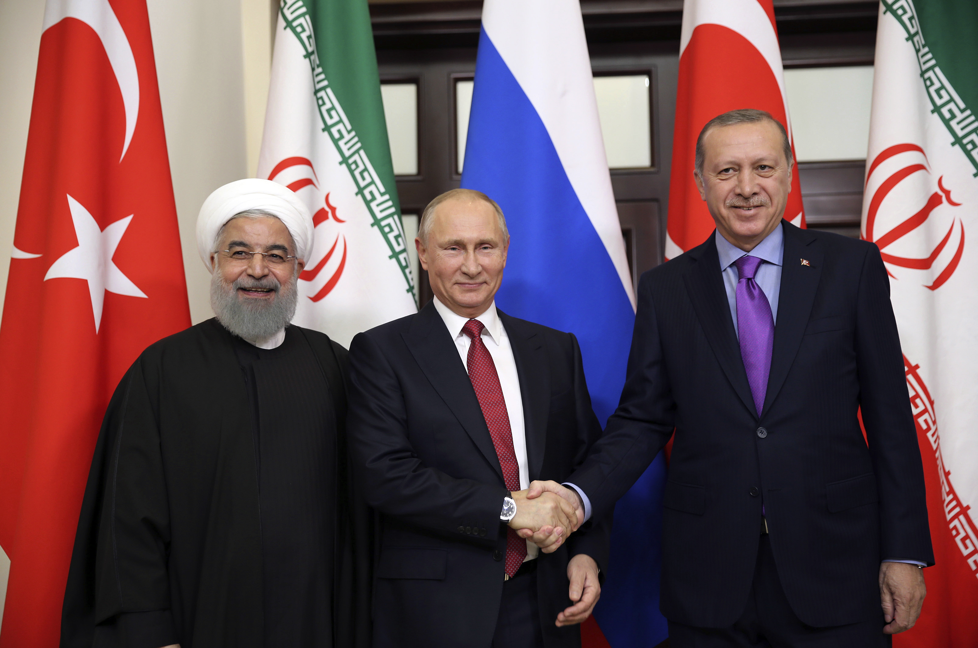 Turkey's President Recep Tayyip Erdogan, right, Russia's President Vladimir Putin, center, and Iran's President Hassan Rouhani pose for the media members in Sochi, Russia, Wednesday, Nov. 22. 2017. (CREDIT: Kayhan Ozer/AP Photo)