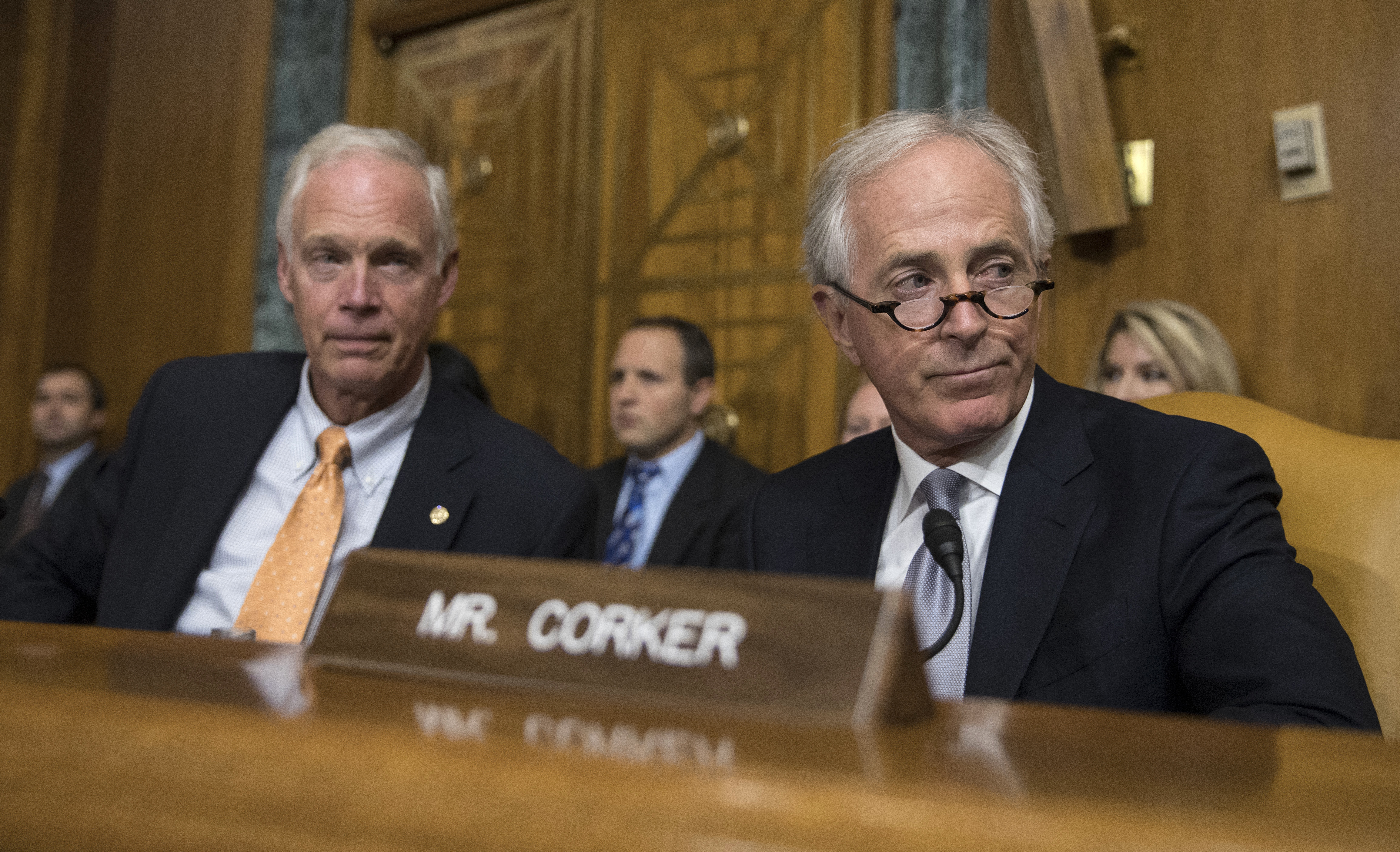 Senate Budget Committee members Sen. Bob Corker, R-Tenn., right, and Sen. Ron Johnson, R-Wis., left attend a Senate Budget Committee hearing to consider fiscal year 2018 reconciliation legislation on Capitol Hill in Washington, Tuesday, Nov. 28, 2017. The committee advanced a sweeping tax package to the full Senate, handing GOP leaders a victory as they try to pass the nation's first tax overhaul in 31 years. (AP Photo/Carolyn Kaster)
