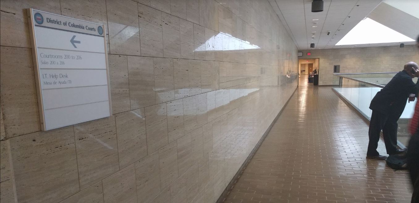 A sign for the I.T. Help Desk outside the Washington, D.C. courtroom where prosecutors are seeking lengthy prison sentences for protesters caught in a police dragnet on Inauguration Day. (CREDIT: ThinkProgress/Alan Pyke)