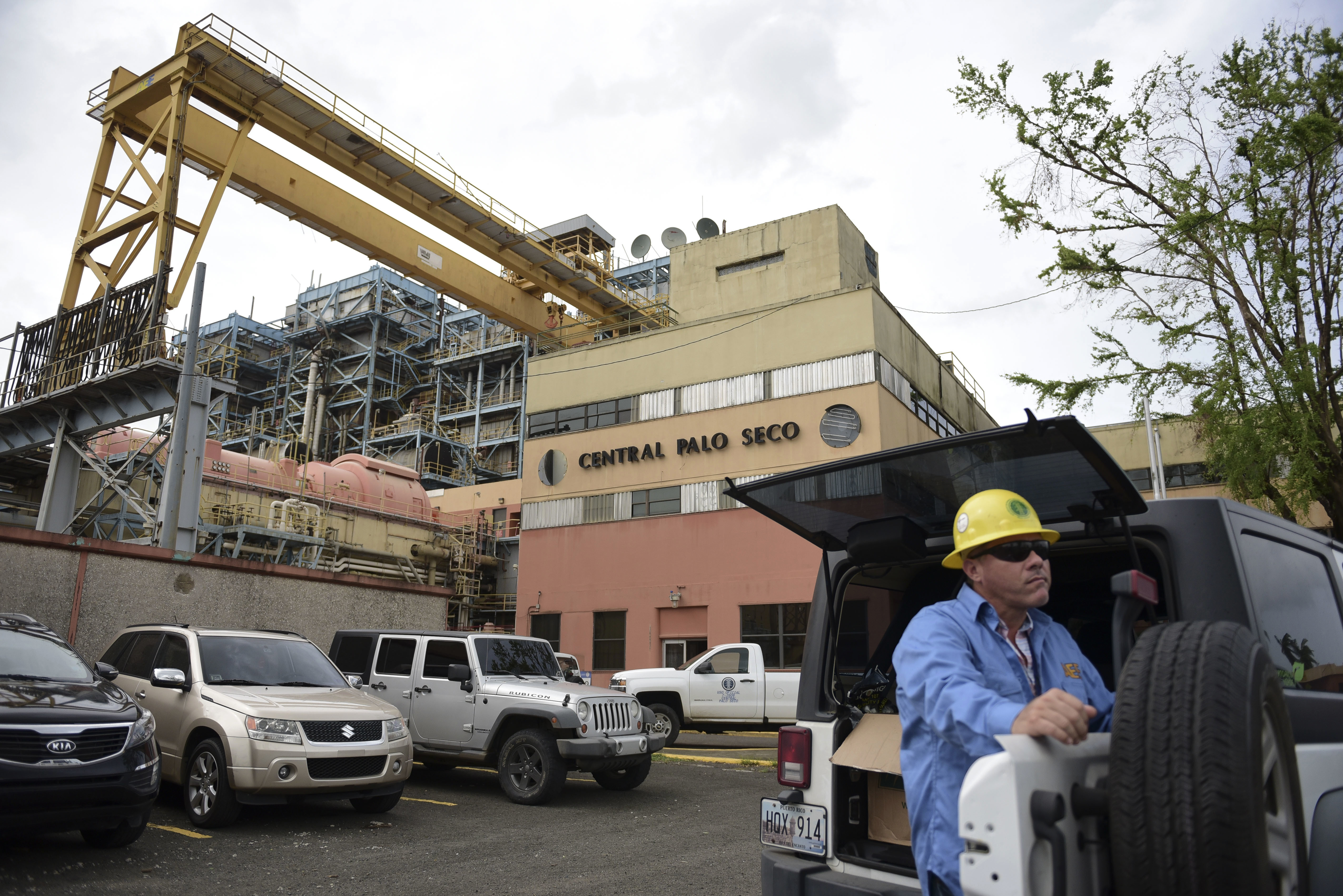 A Puerto Rico electric utility employee waits for Gov. Ricardo Rossello and staff from the U.S. Army Corps of Engineers to take a tour of the oil-fired Palo Seco power plant on October 18, 2017. CREDIT: AP Photo/Carlos Giusti