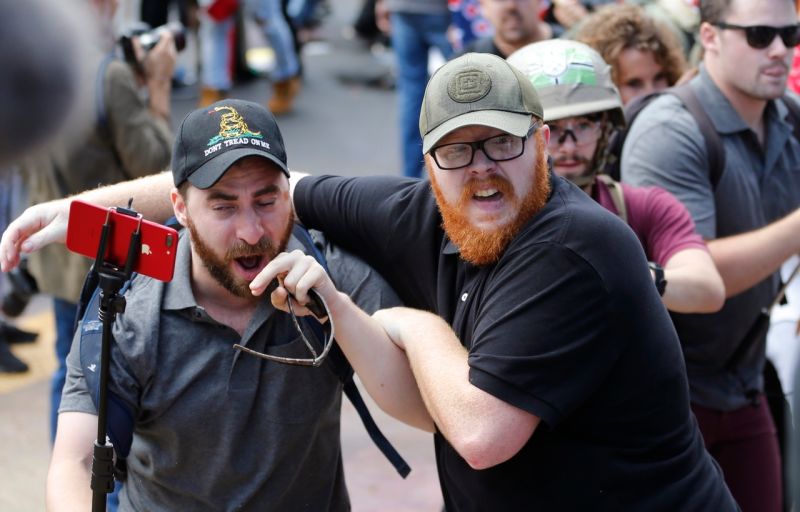 Baked Alaska (left) and his bodyguard (right) during the Charlottesville protest in August (AP Photo/Steve Helber)