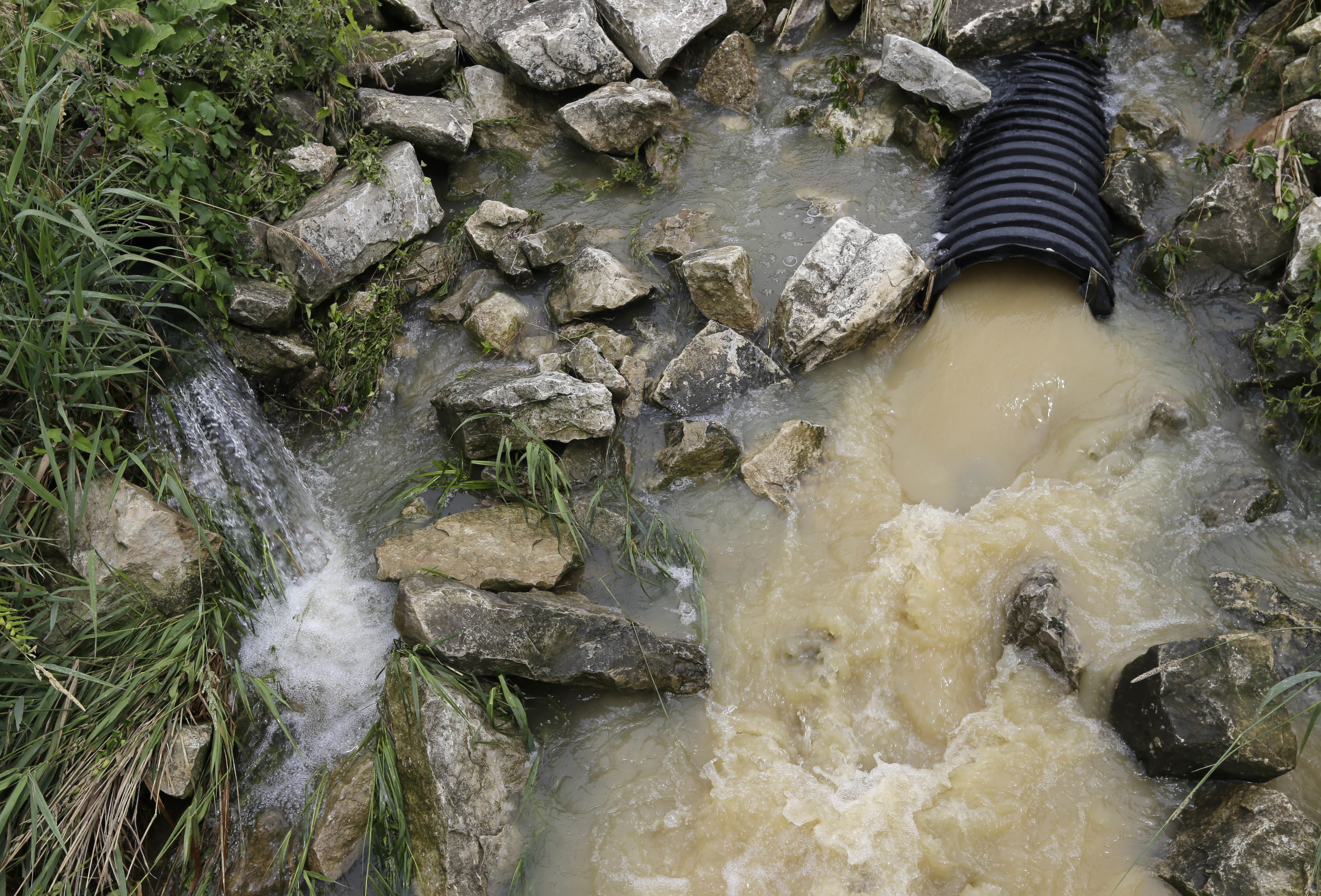 In this July 12, 2017 photo, muddy water from the construction of Energy Transfer Partners' Rover Pipeline seeps into a creek in New Washington, Ohio. (CREDIT: AP Photo/Tony Dejak)