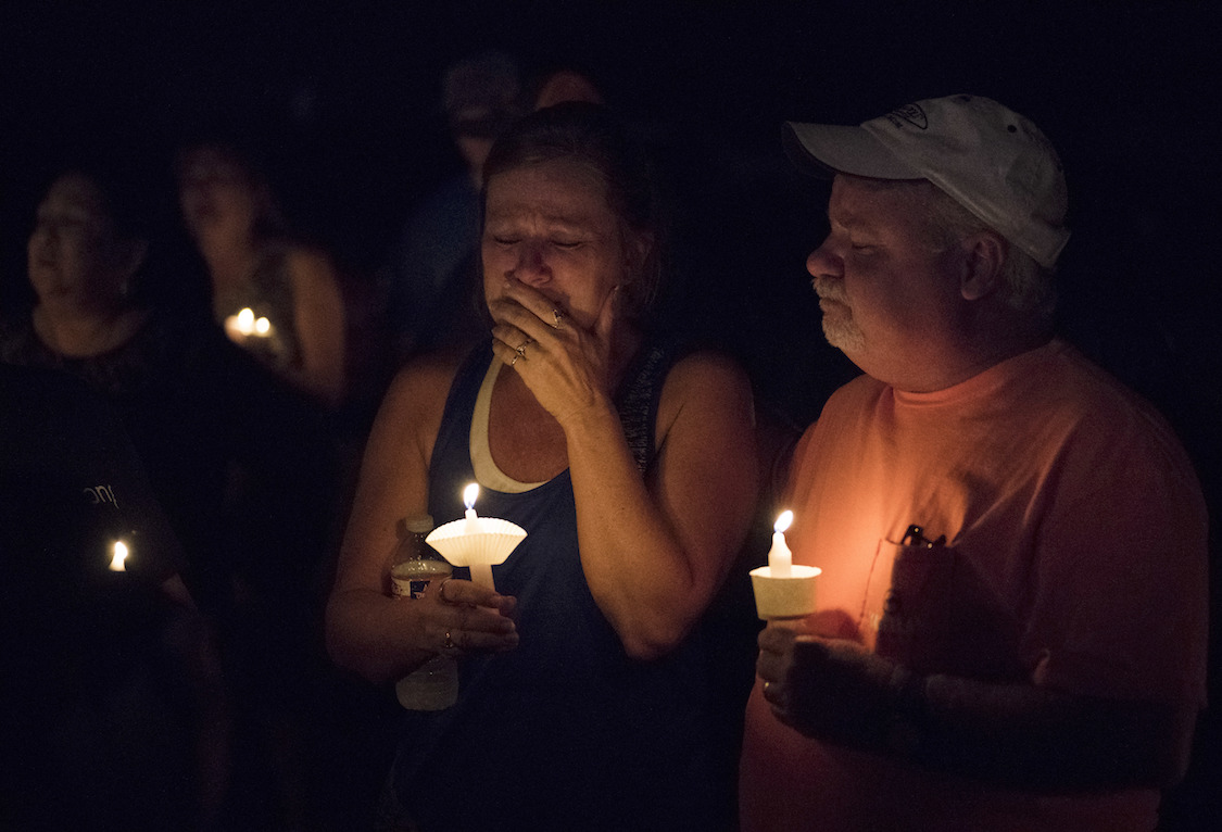 Mourners participate in a candlelight vigil for the victims of a fatal shooting at the First Baptist Church of Sutherland Springs, Sunday, Nov. 5, 2017, in Sutherland Springs, Texas. (CREDIT: AP/Darren Abate)