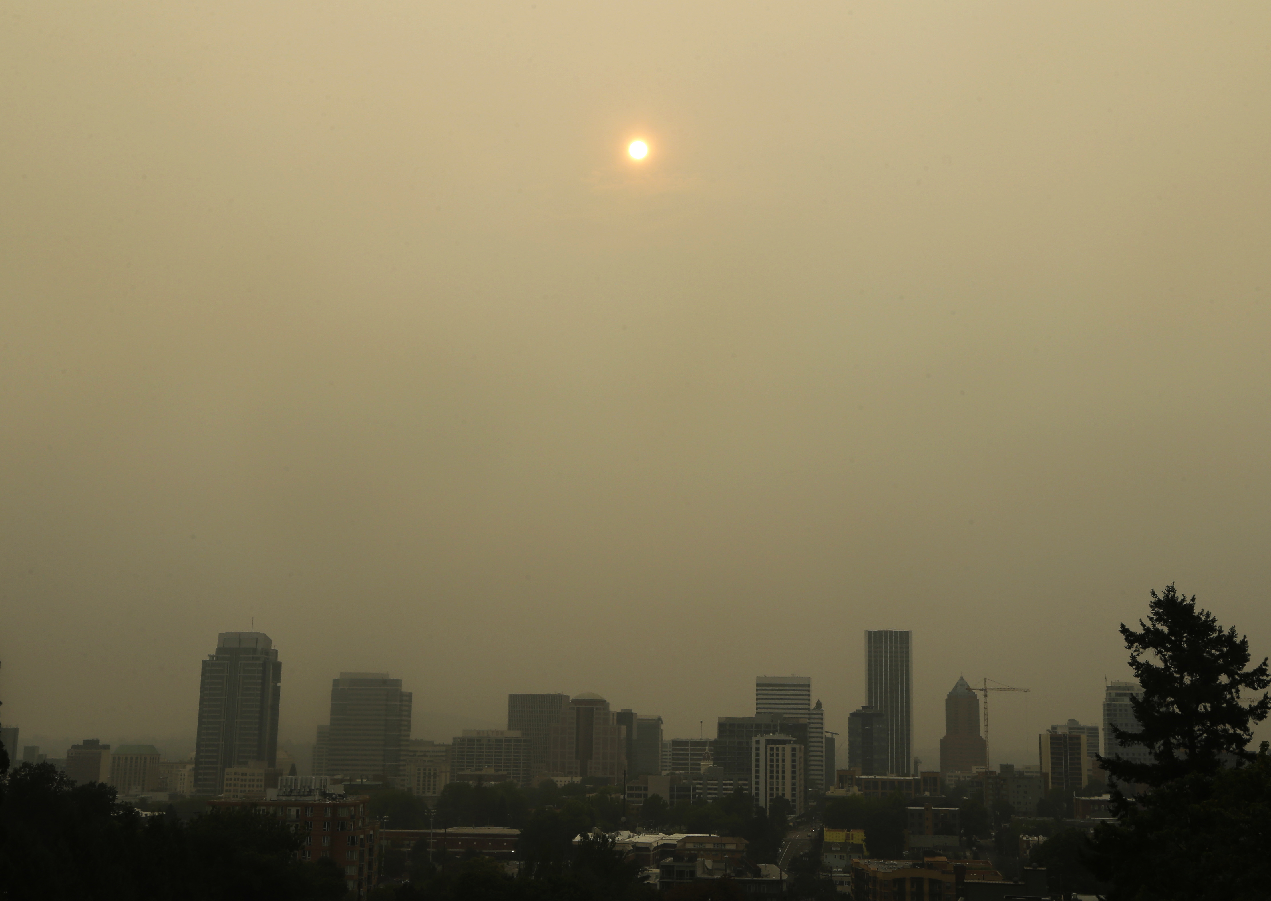 The sun over downtown Portland, OR, as seen through smoke from wildfires burning in the Columbia River Gorge. (CREDIT: AP Photo/Don Ryan)