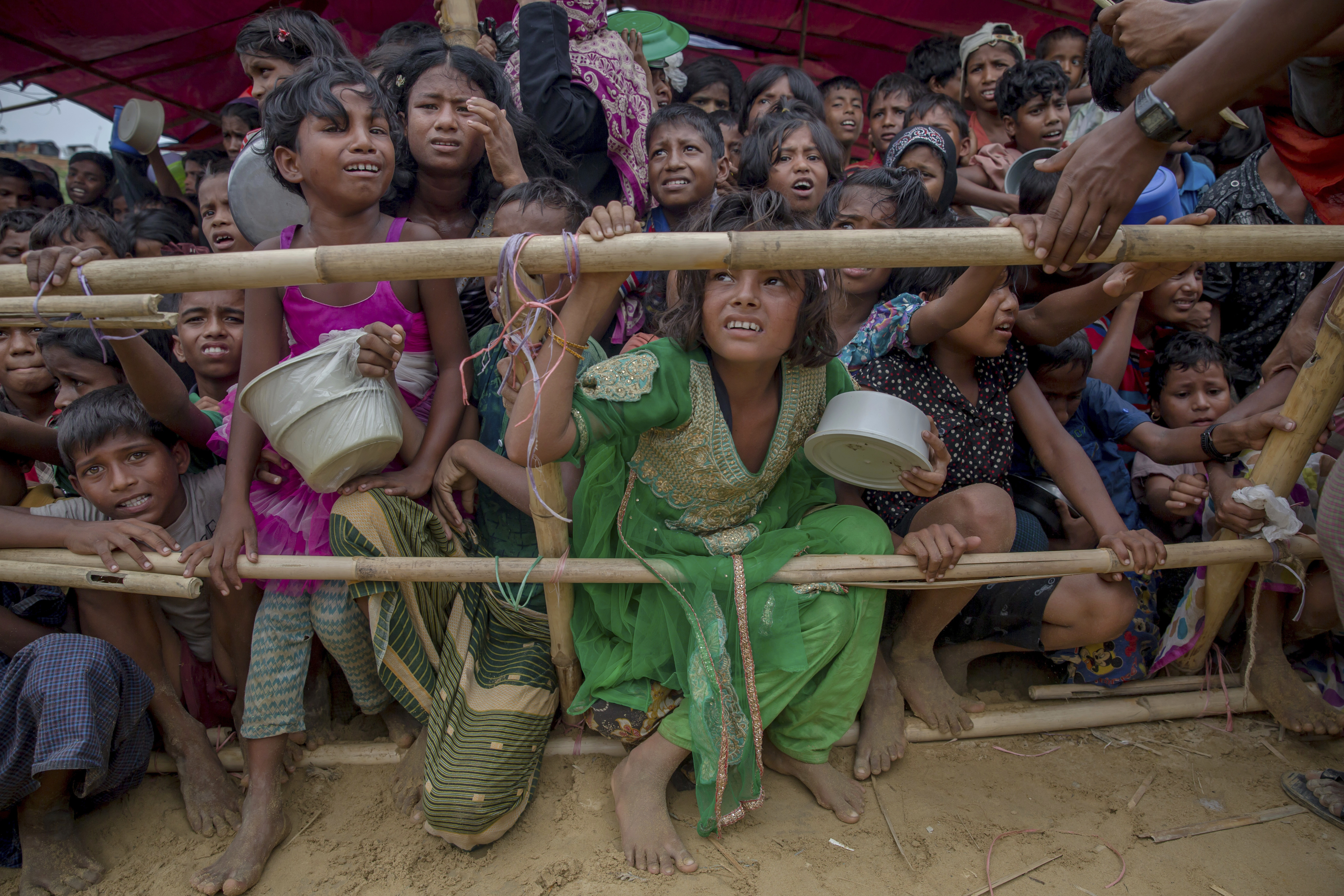 UNICEF says the children who make up most of the over 600,000 Rohingya Muslims who have fled violence in Myanmar are seeing a "hell on earth" in overcrowded, muddy and squalid refugee camps in neighboring Bangladesh. (CREDIT: Dar Yasin/AP Photo.)