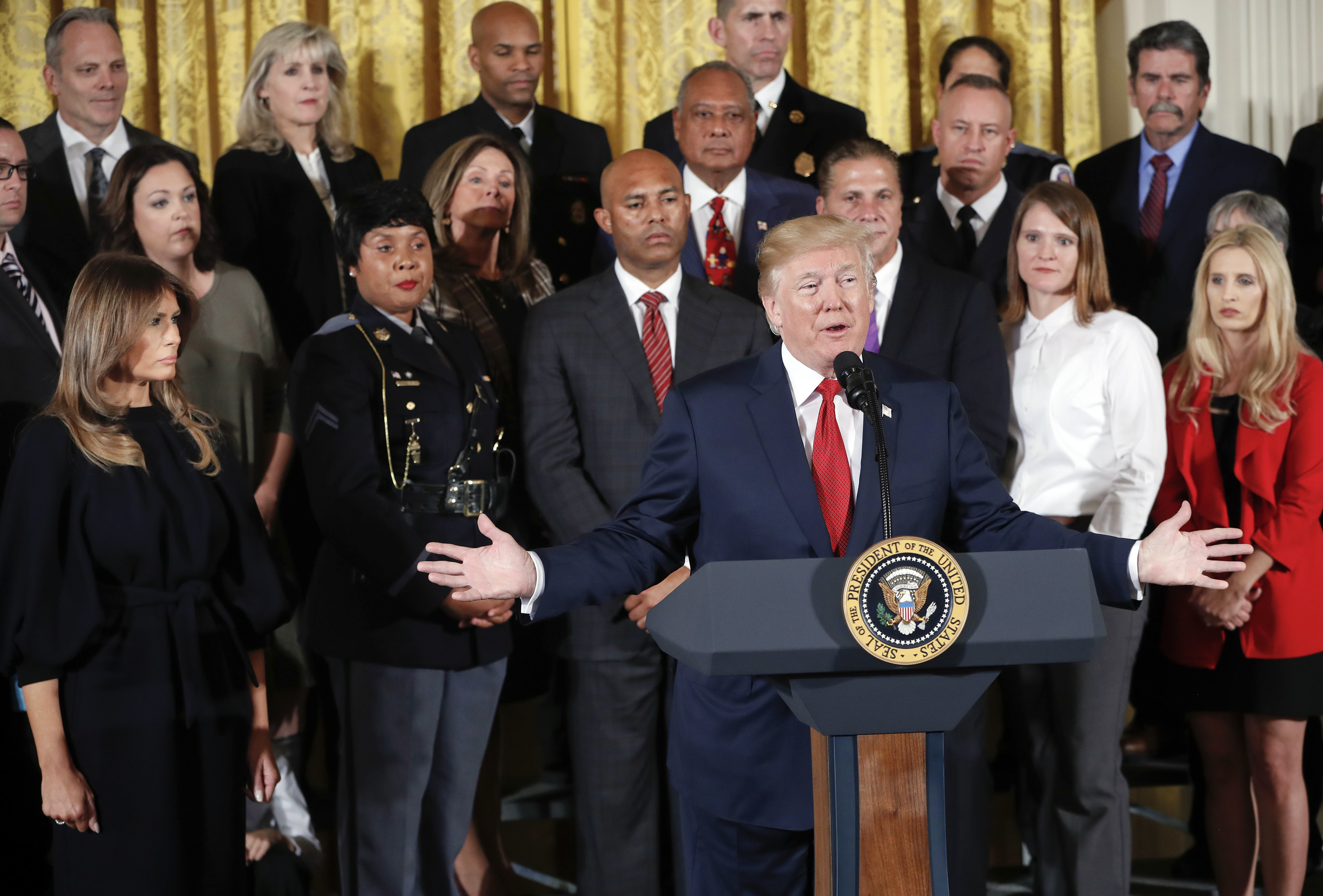 President Donald Trump and first lady Melania Trump, left, speaks on the opioid crisis in the East Room of the White House in Washington, Thursday, Oct. 26, 2017. (AP Photo/Pablo Martinez Monsivais)