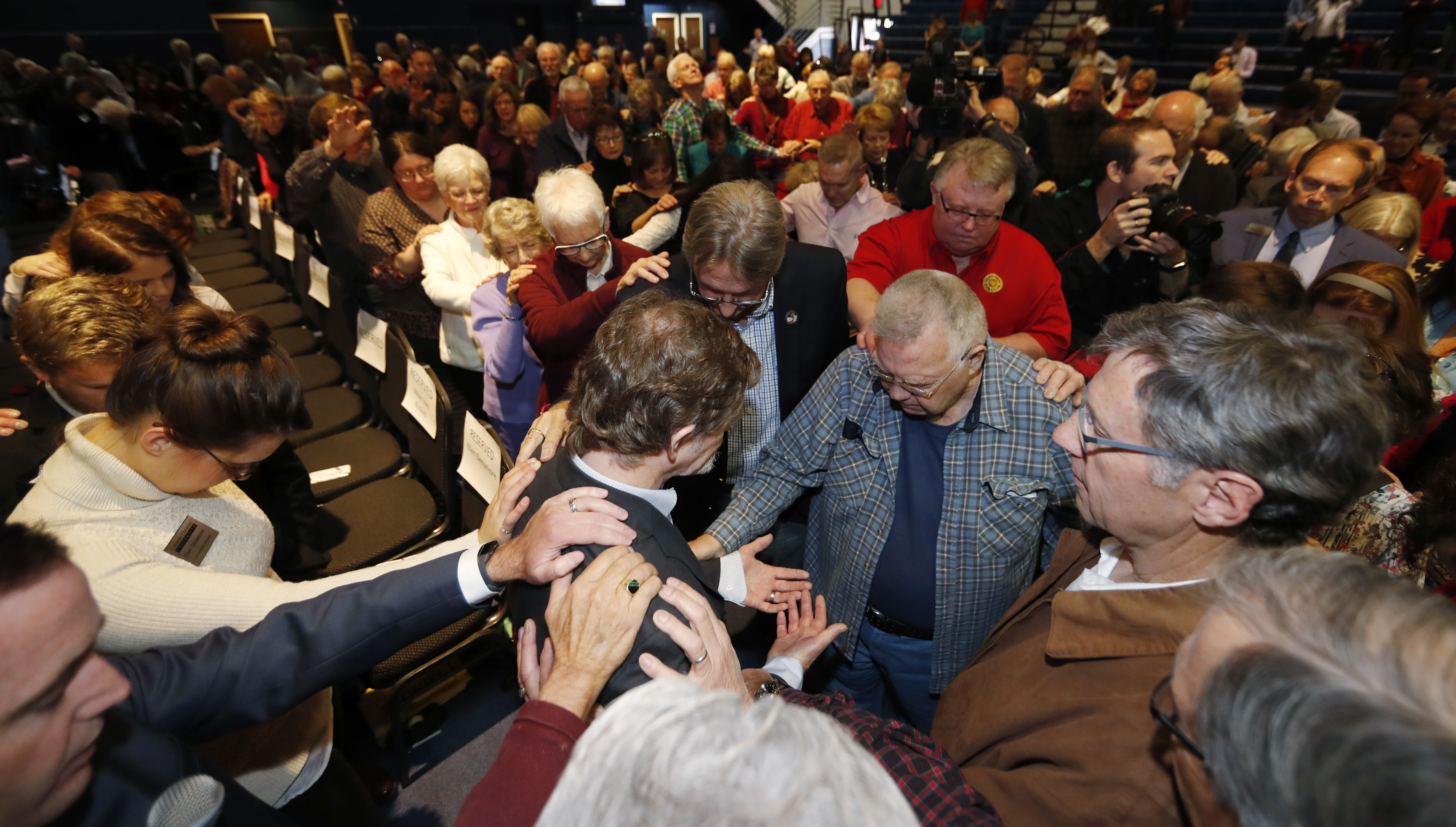 Jack Phillips' supporters offer him a prayer of support. CREDIT: AP Photo/David Zalubowski