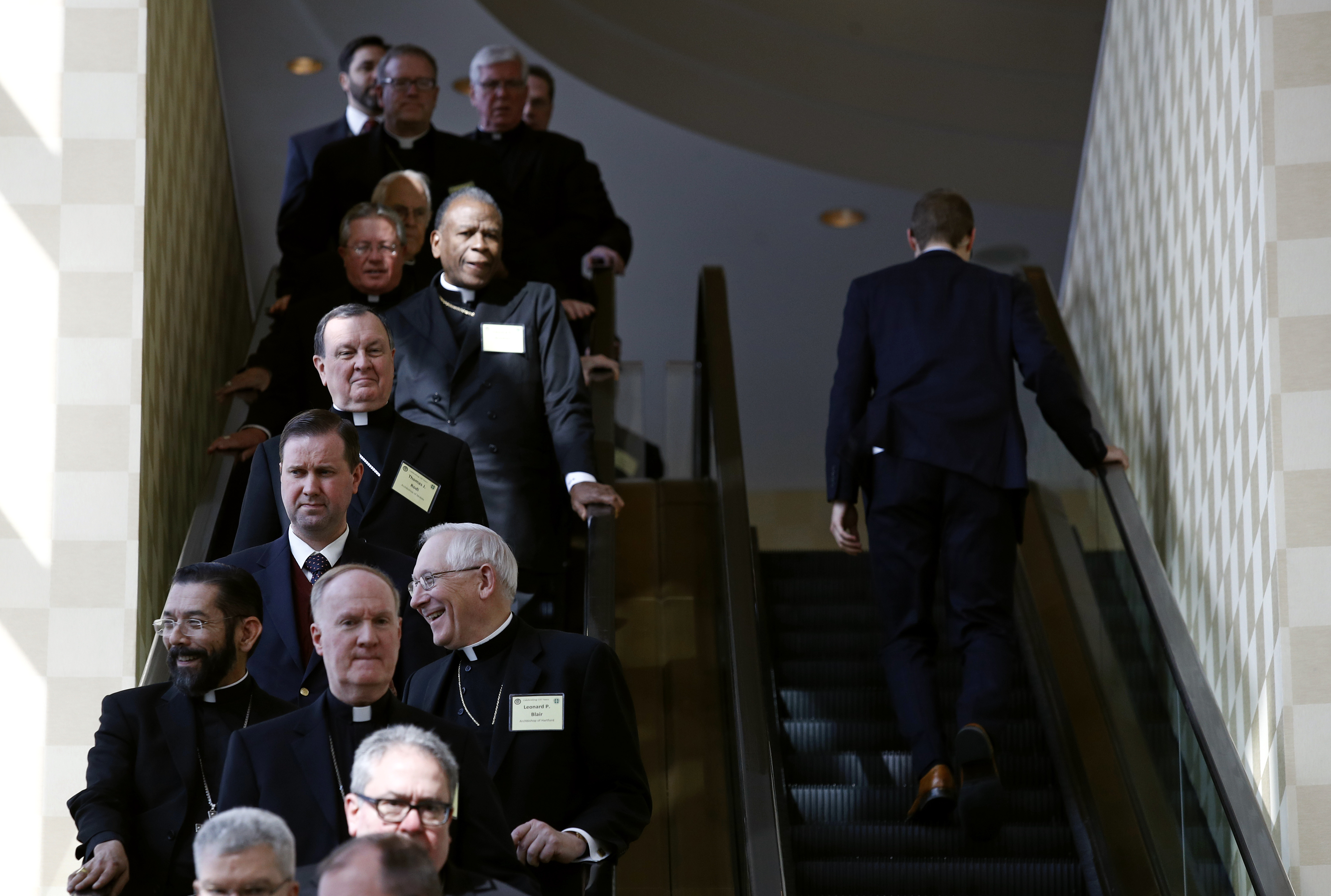 Members of the the United States Conference of Catholic Bishops ride an escalator during a break in sessions at the USCCB's annual fall meeting. CREDIT: AP Photo/Patrick Semansky