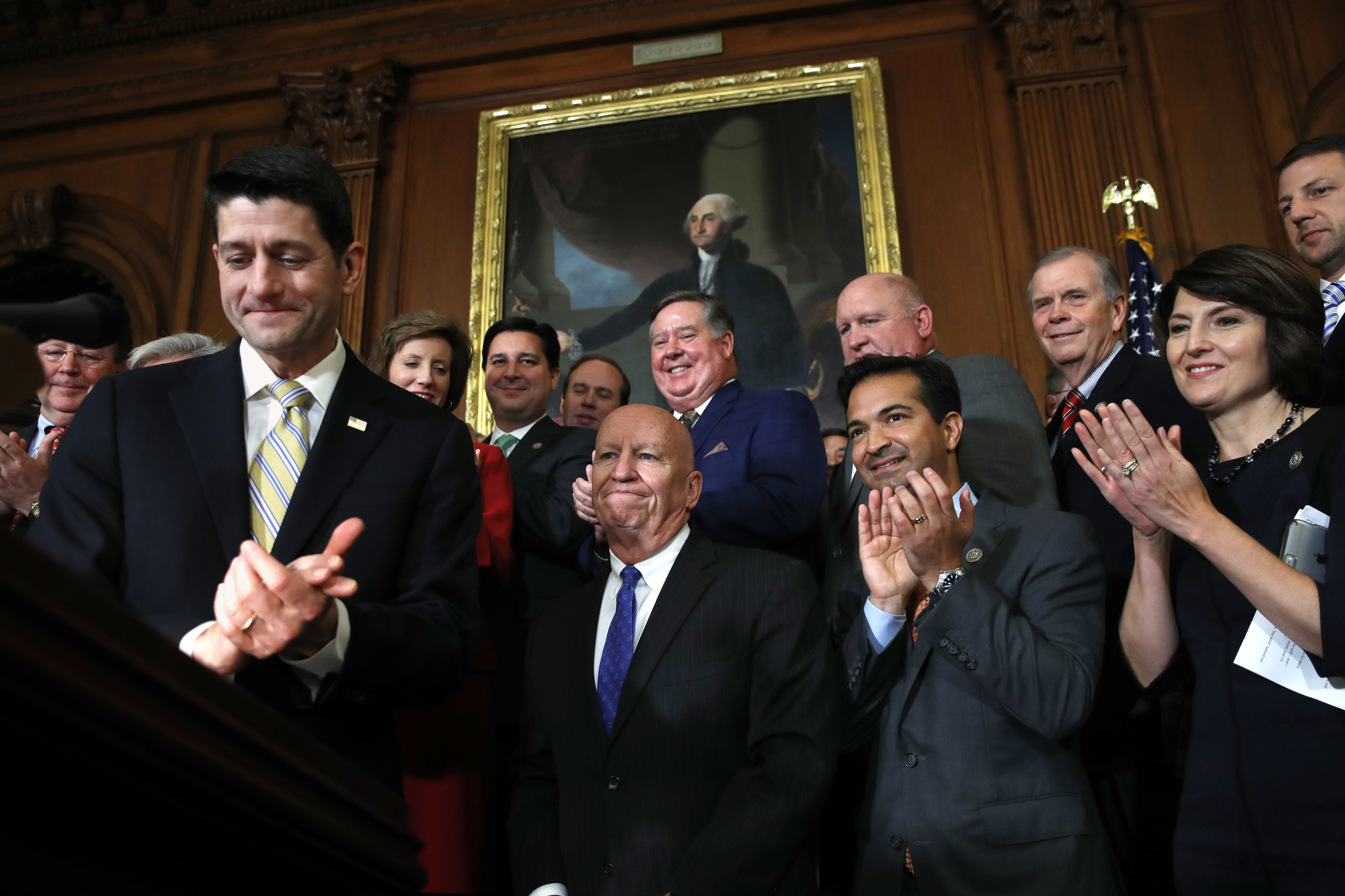 Republicans celebrate after passing a near $1.5 trillion package overhauling corporate and personal taxes through the House (CREDIT: AP Photo/Jacquelyn Martin)