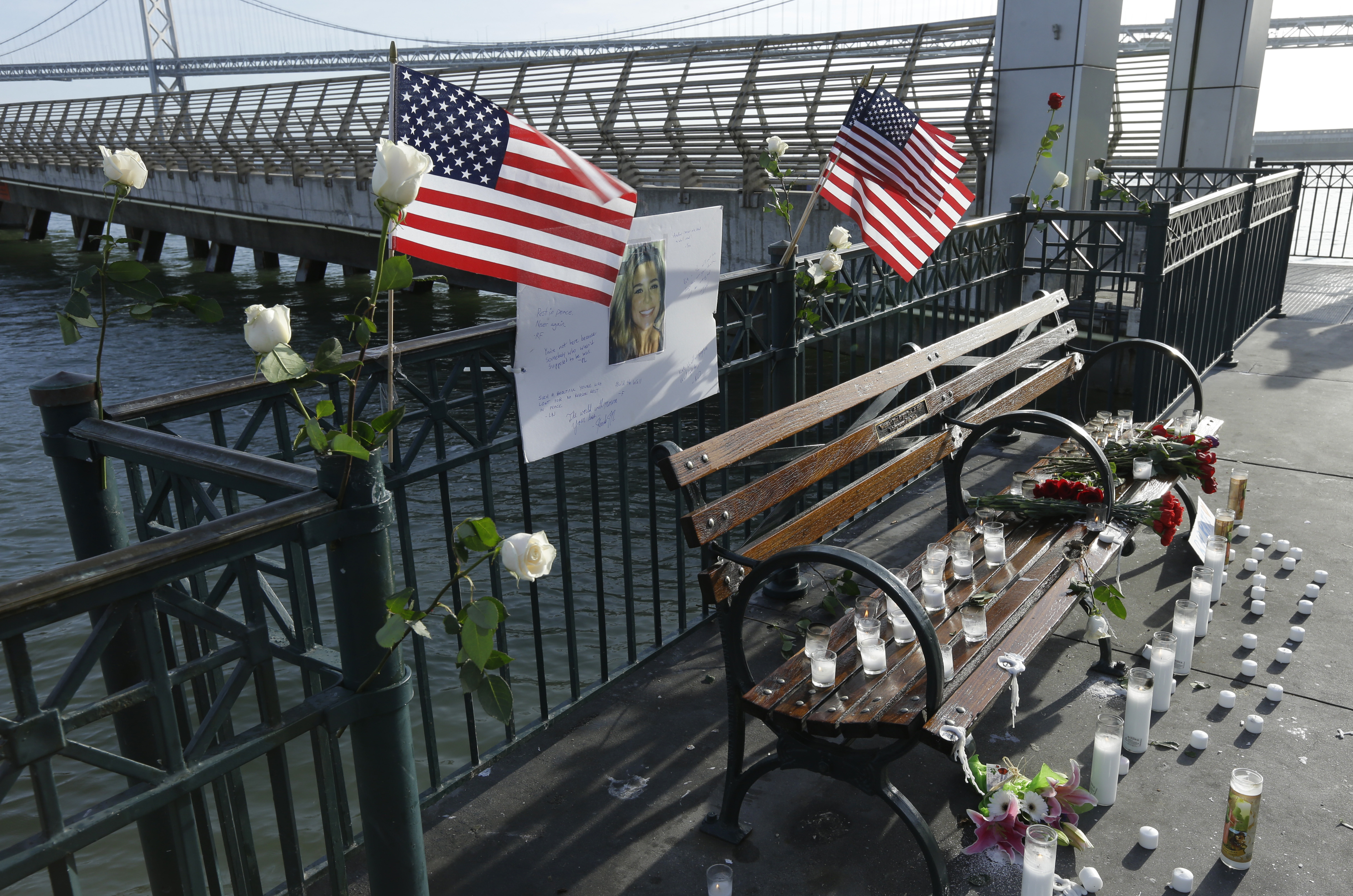 Flowers and a portrait of Kate Steinle remain at a memorial site on Pier 14 Friday, Dec. 1, 2017, in San Francisco. CREDIT: AP Photo/Ben Margot