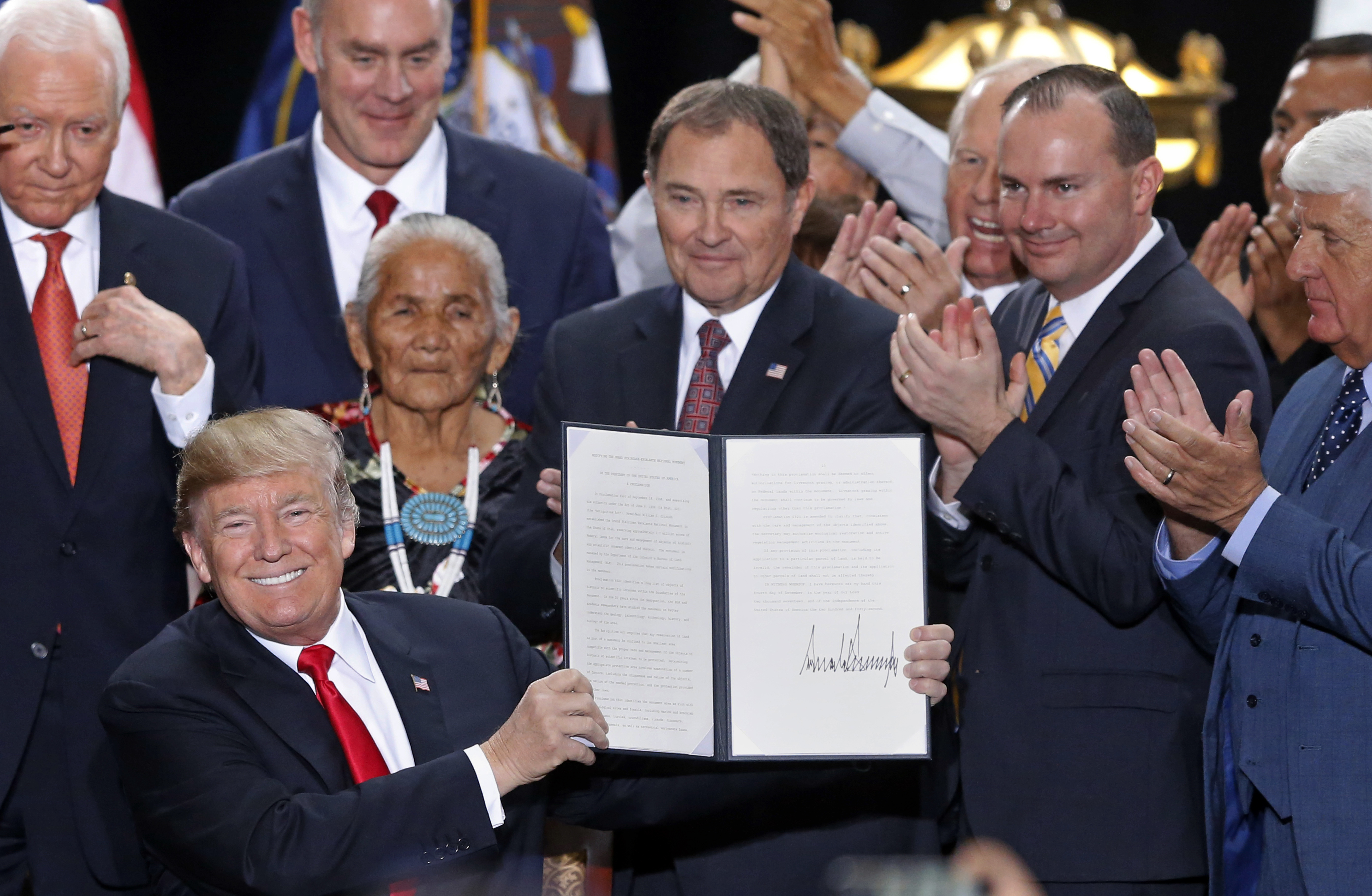 President Donald Trump signs an order shrinking two national monuments in Utah on December 5, 2017.
(CREDIT: AP Photo/Rick Bowmer)