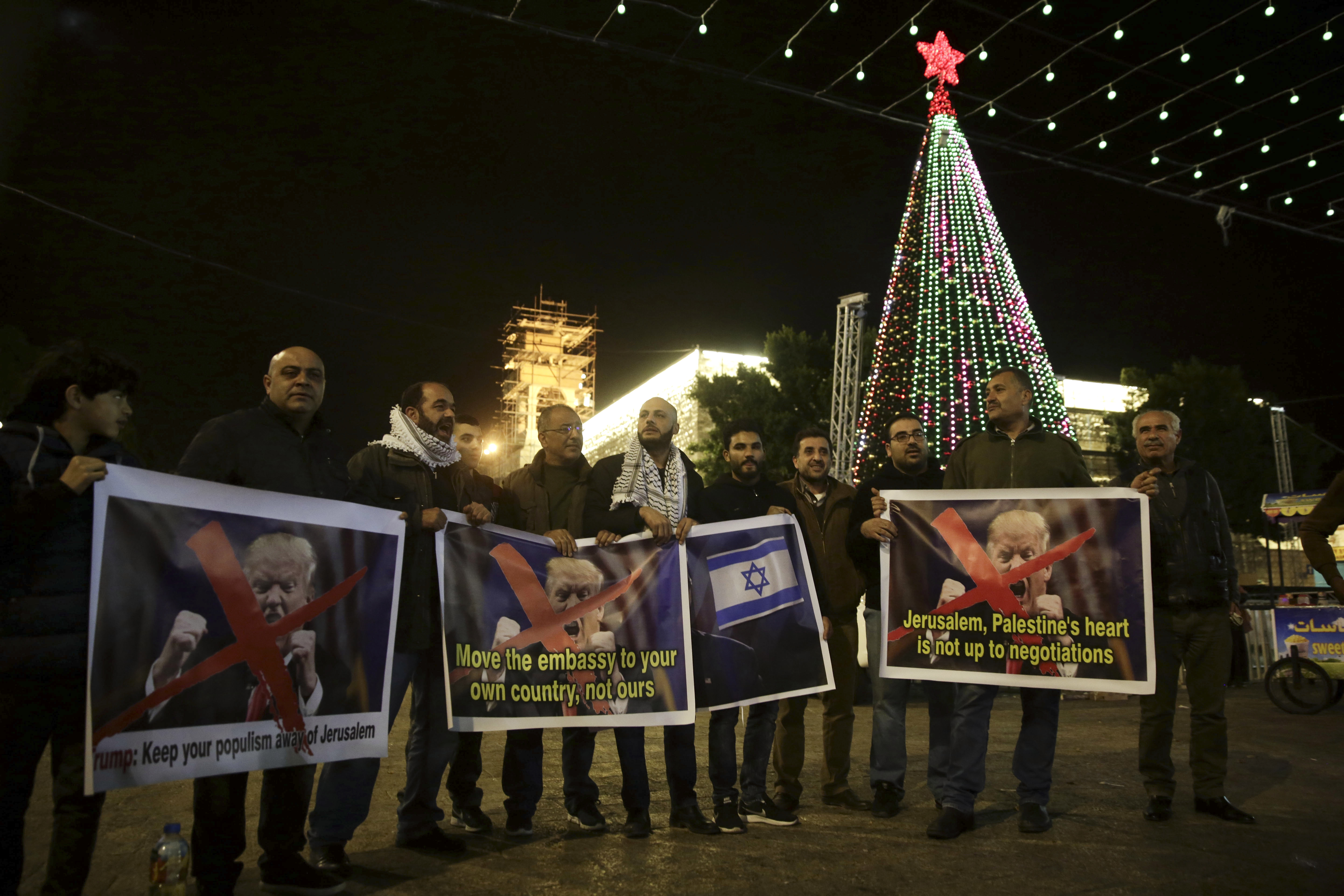 Palestinian hold posters of the U.S. President Donald Trump during a protest in Bethlehem, West Bank, Tuesday, Dec. 6, 2017. President Trump forged ahead Tuesday with plans to recognize Jerusalem as Israel's capital despite intense Arab, Muslim and European opposition to a move that would upend decades of U.S. policy and risk potentially violent protests. CREDIT: AP Photo/Mahmoud Illean
