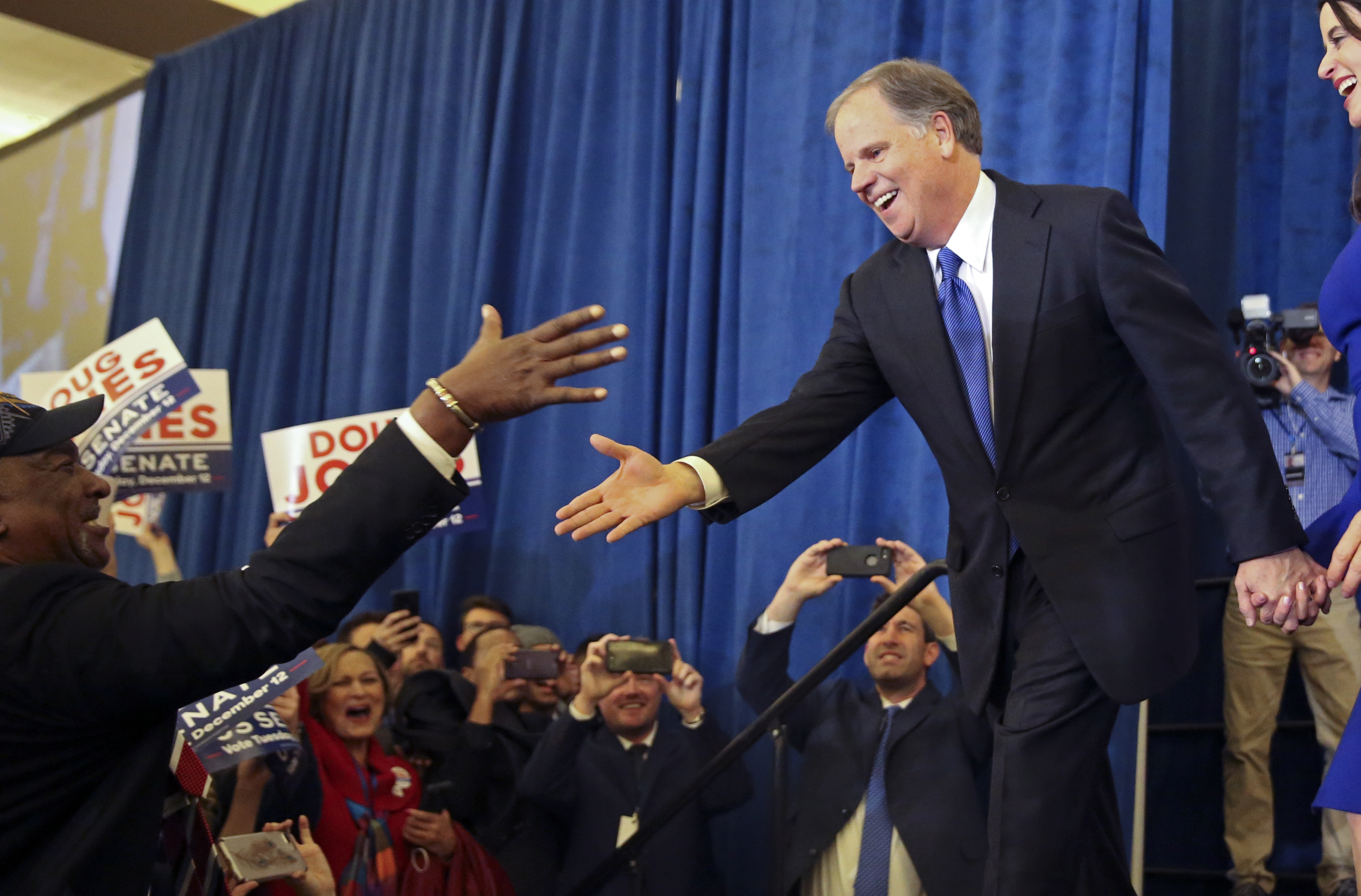 Doug Jones is greeted by a supporter on election night in Birmingham. CREDIT: AP Photo/John Bazemore