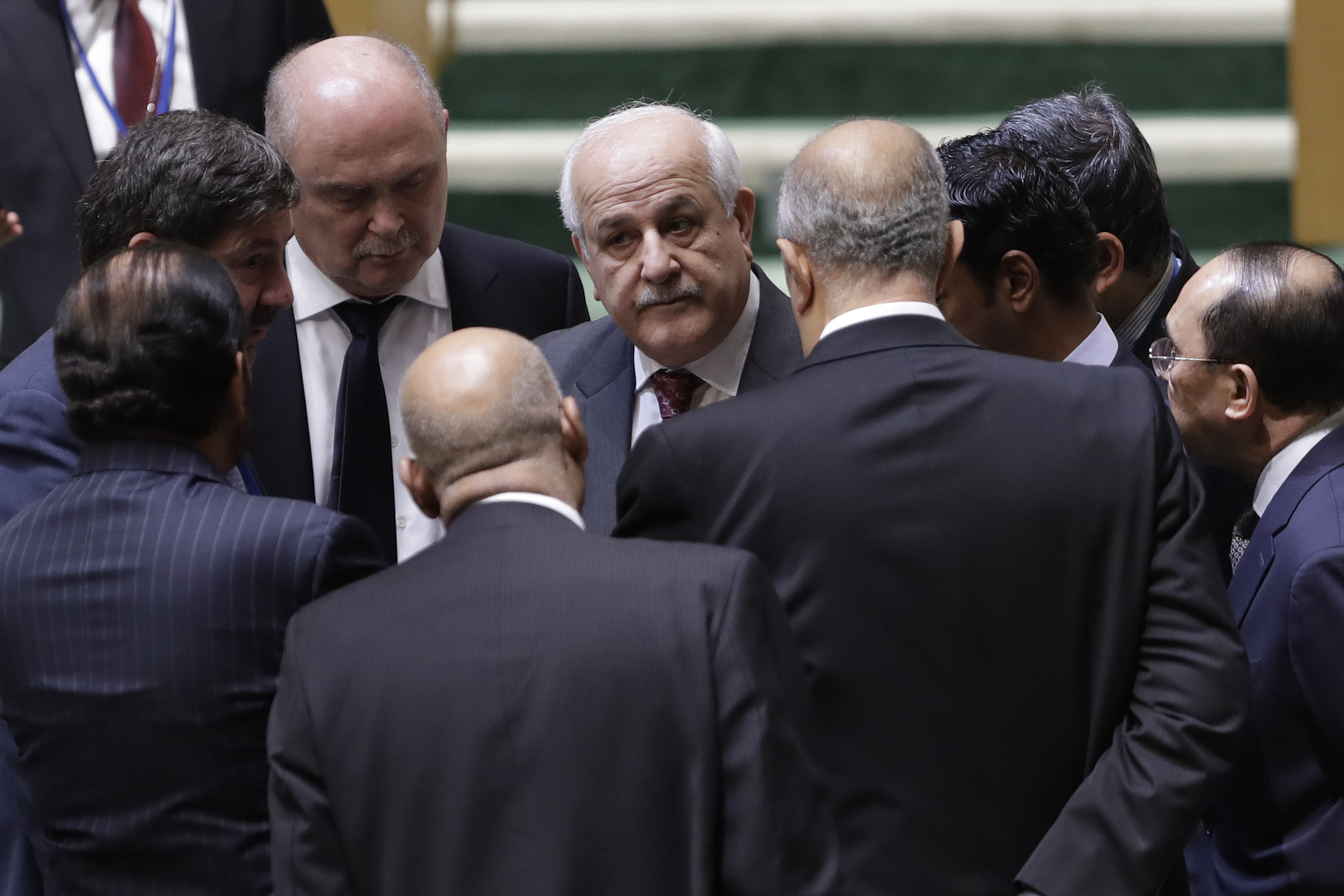 Palestinian Ambassador to the United Nations Riyad Mansour, center, talks with members of the General Assembly prior to a vote, Thursday, Dec. 21, 2017, at United Nations headquarters. President Donald Trump's threat to cut off U.S. funding to countries that oppose his decision to recognize Jerusalem as Israel's capital has raised the stakes in Thursday's U.N. vote and sparked criticism of his tactics, with one Muslim group calling it bullying or blackmail. CREDIT: Mark Lennihan/AP Photo.