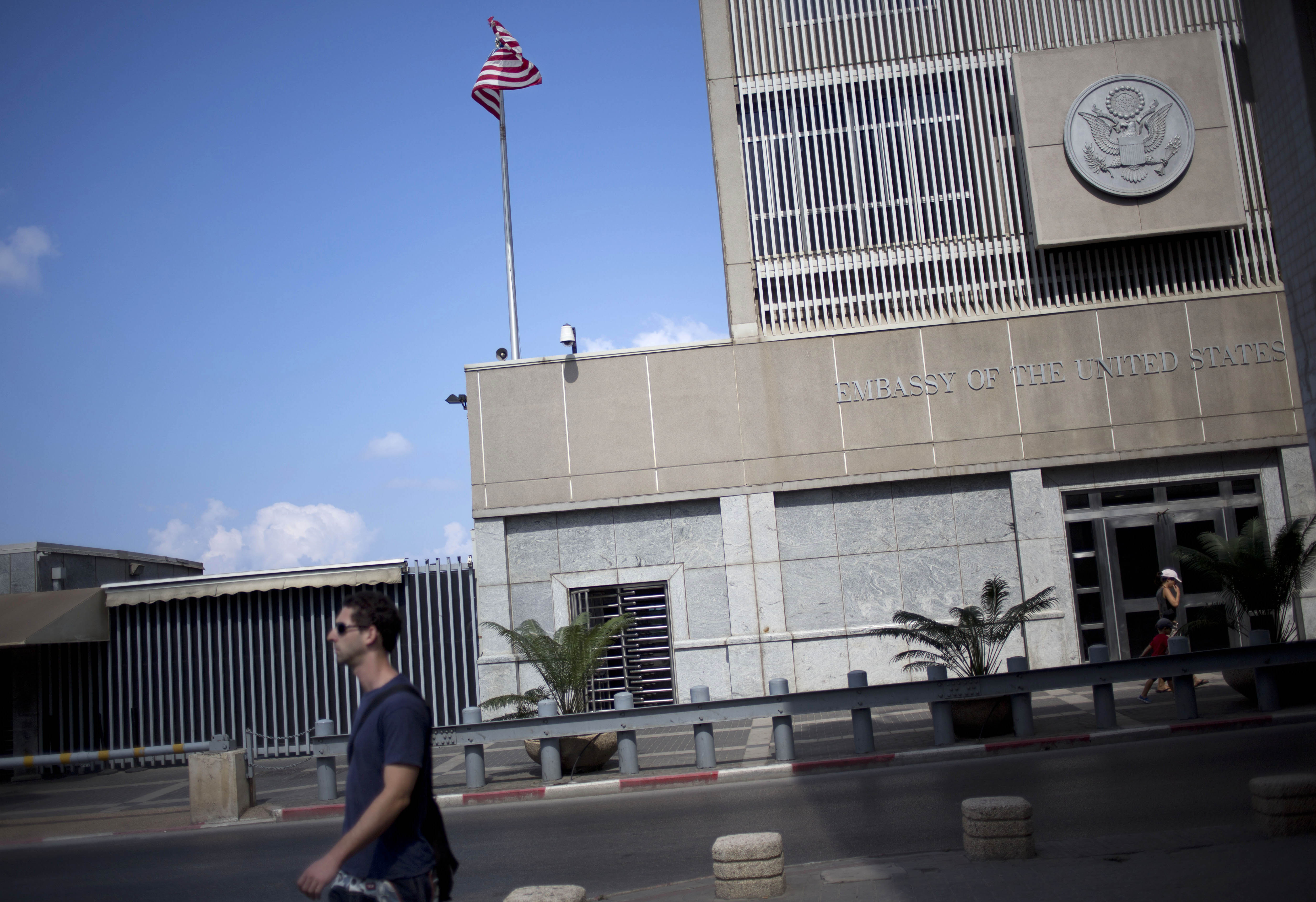 A man walks past the U.S Embassy in Tel Aviv, Israel, Sunday, August 4, 2013. (CREDIT: AP Photo/Ariel Schalit)