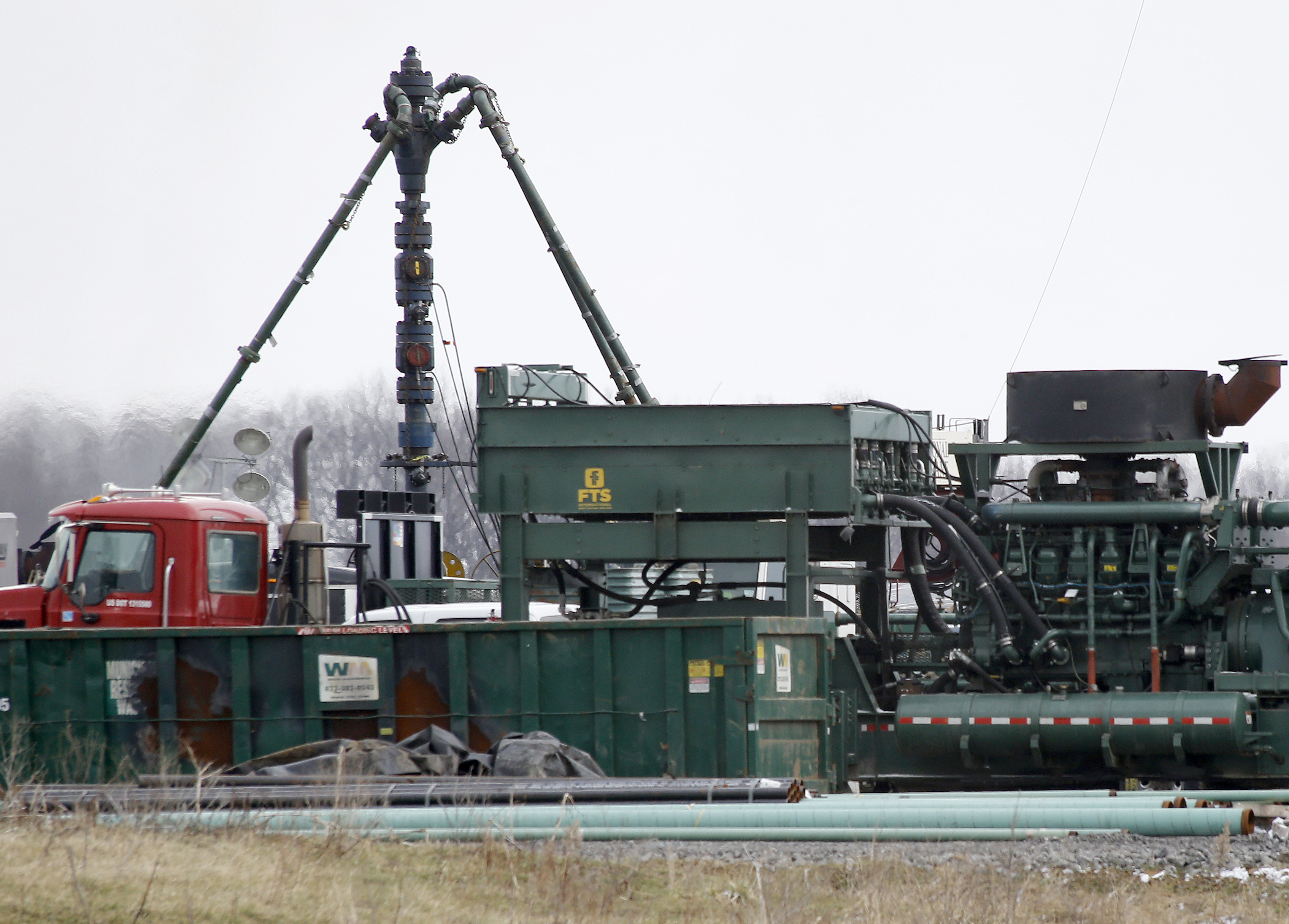 A pumping truck is seen near a natural gas well that underwent fracking in Zelienople, Pennsylvania. CREDIT: AP Photo/Keith Srakocic