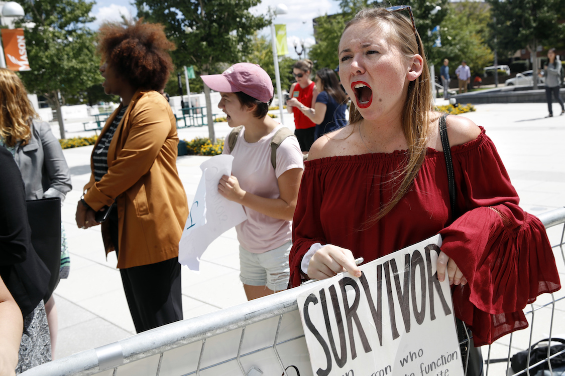 Meghan Downey, 22, a recent graduate from the College of William & Mary, reacts outside an auditorium after Education Secretary Betsy DeVos spoke about proposed changes to Title IX, Thursday, Sept. 7, 2017, at George Mason University Arlington, Va., campus. CREDIT: AP/Jacquelyn Martin