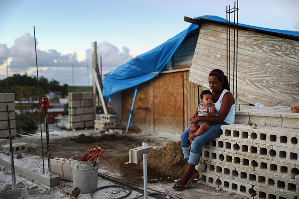 Mother Isamar holds her baby in San Juan. CREDIT: Mario Tama/Getty Images