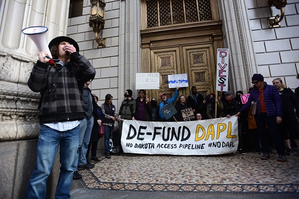 Demonstrators rally outside a US Bank branch in Portland, Oregon, to protest the bank's funding of the Dakota Access Pipeline. After pulling its funding from Dakota Access, US Bank is now funding another oil pipeline in Louisiana. CREDIT: Alex Milan Tracy/Anadolu Agency/Getty Images