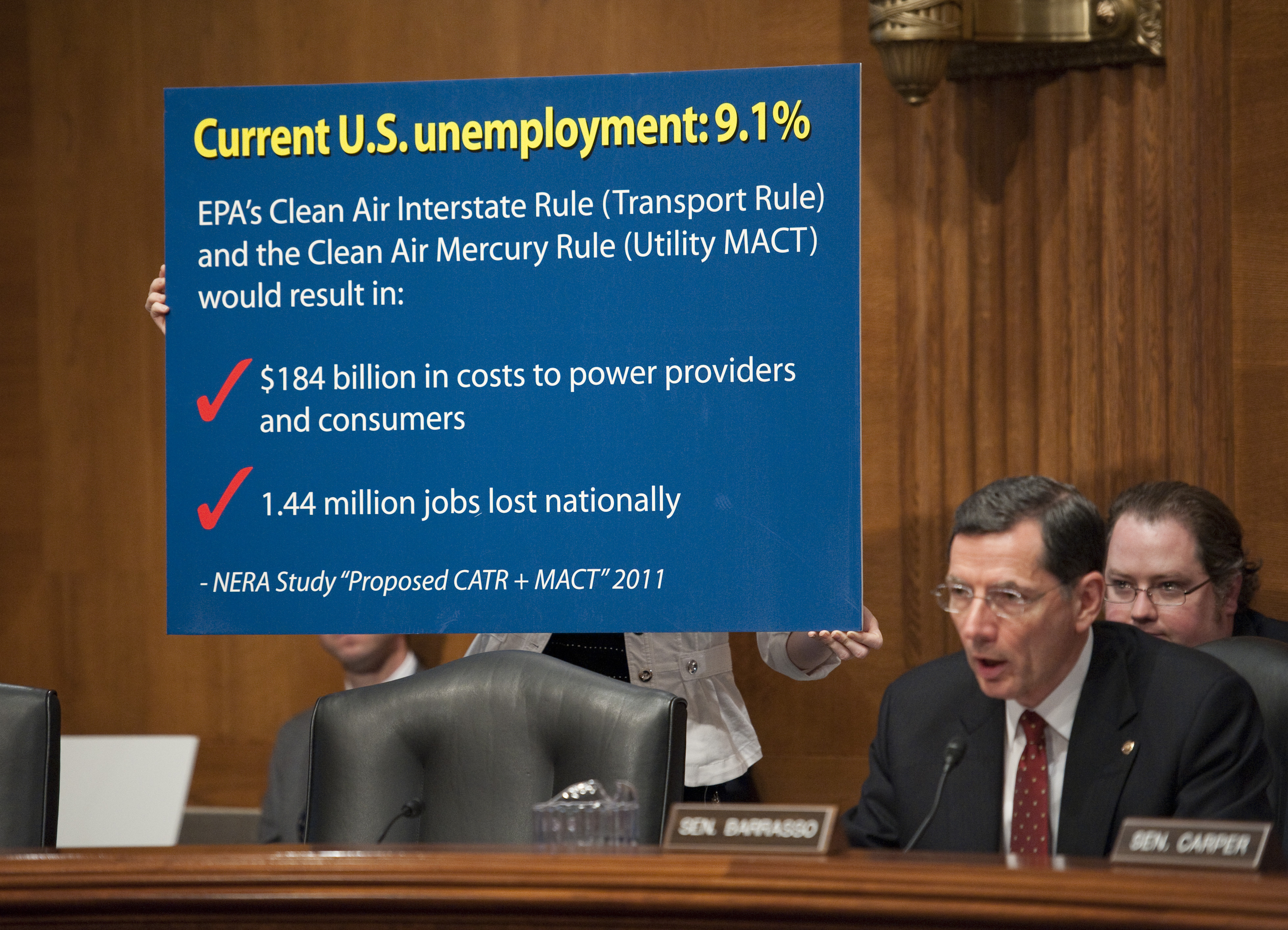 An aide holds a chart for ranking member John Barrasso (R-WY) during the Senate Environment and Public Works Subcommittee on Clean Air and Nuclear Safety hearing in June. (CREDIT: Scott J. Ferrell/Congressional Quarterly/Getty Images)