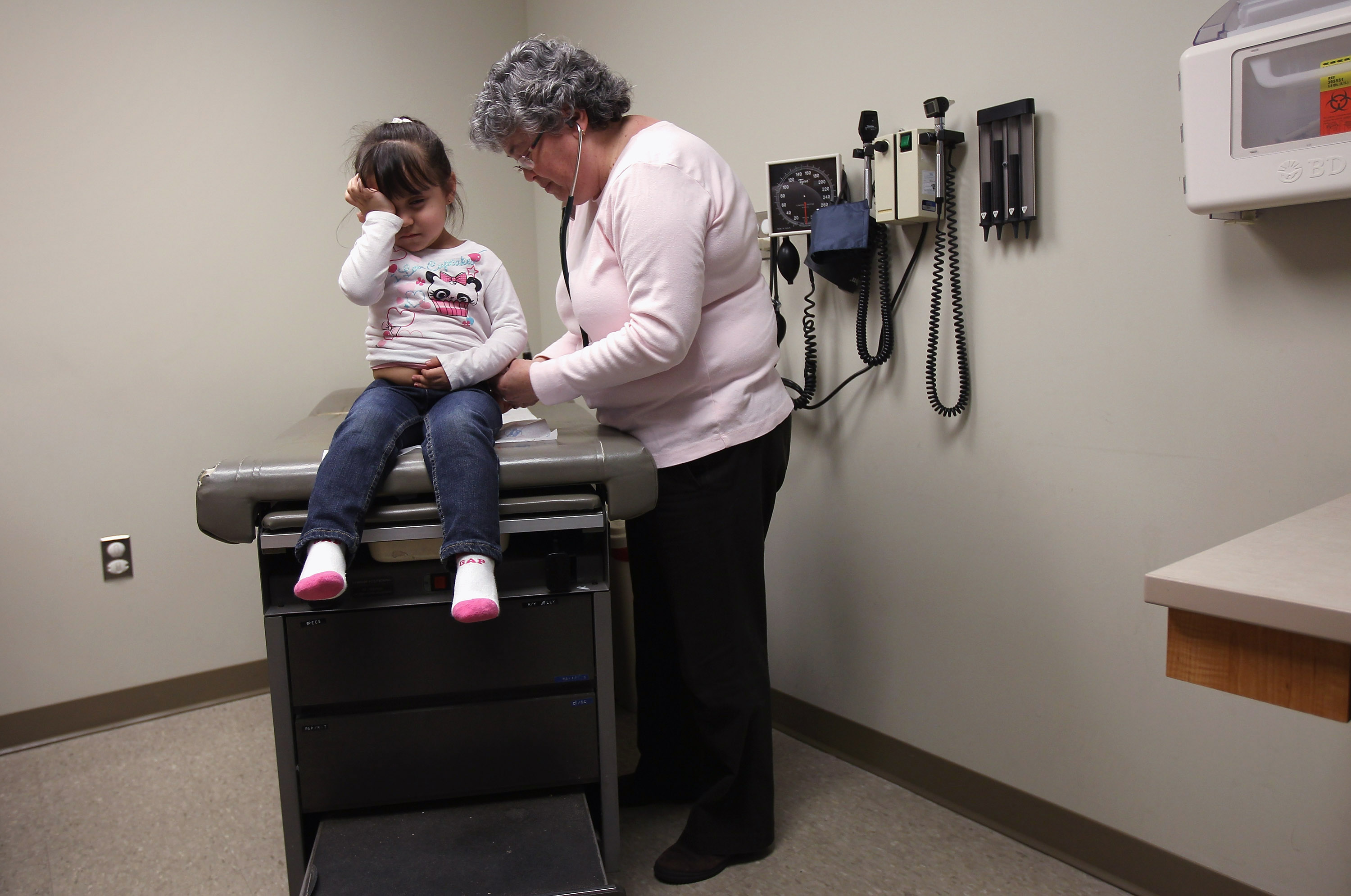AURORA, CO - MARCH 27: Physician's assistant Ann Valdez checks out Amy Morales, 2, during a check-up at a community health center on March 27, 2012 in Aurora, Colorado. The center, called the Metro Community Provider Network, has received some 6,000 more Medicaid eligable patients since the healthcare reform law was passed in 2010. (Photo by John Moore/Getty Images)