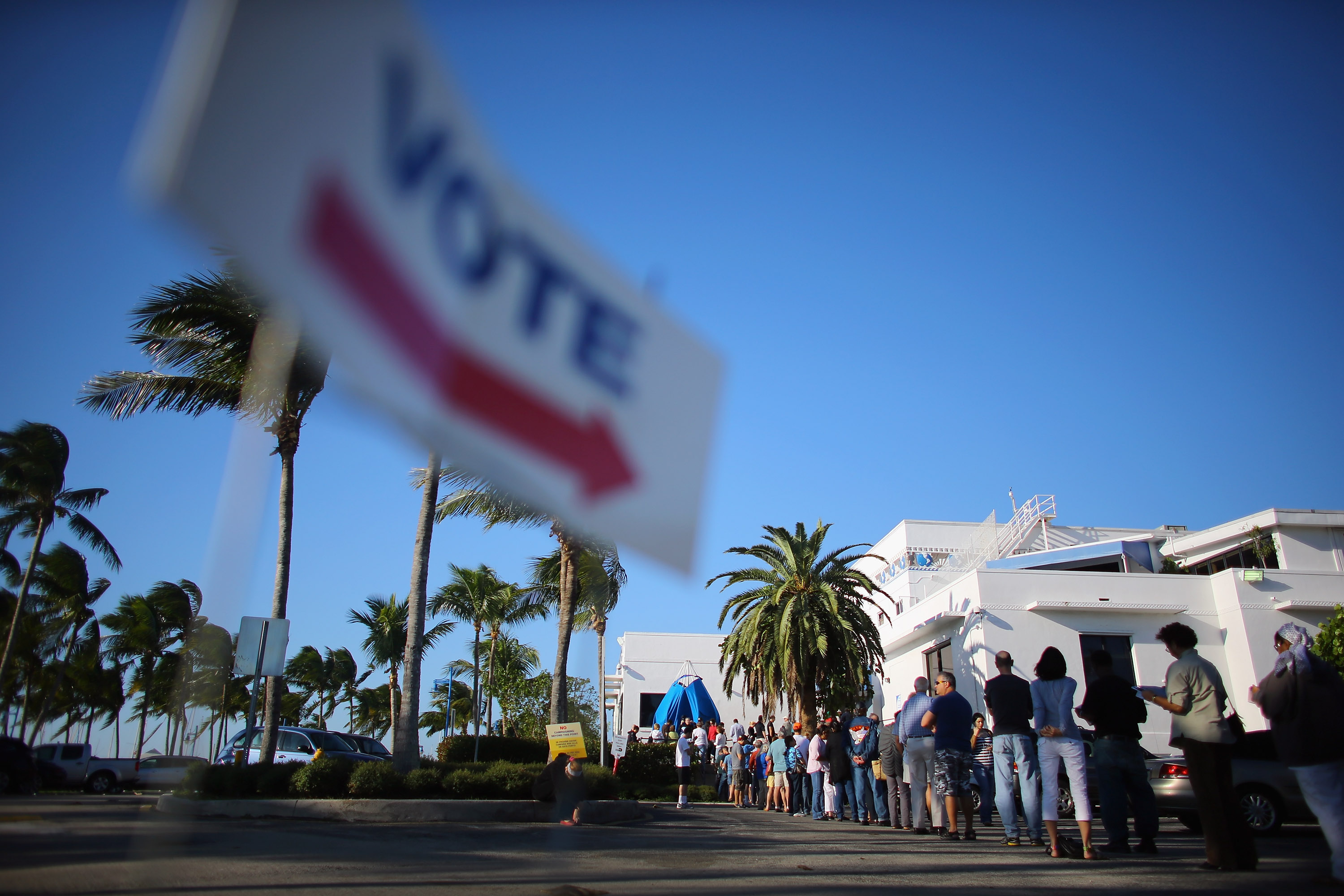 Early voters wait in line to vote in the presidential election on the first day of early voting at a polling station setup at the City of Miami City Hall on October 27, 2012 in Miami, Florida. CREDIT: Joe Raedle/Getty Images
