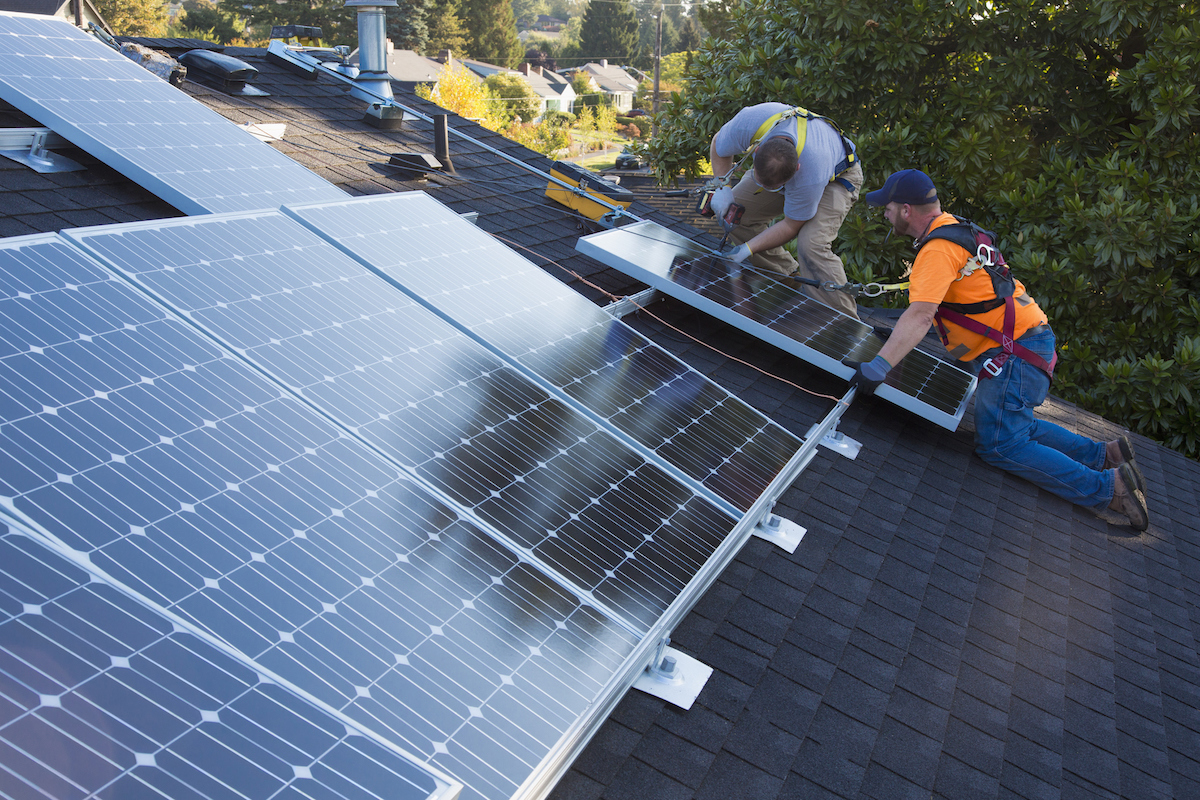 Solar panel installers. CREDIT: Don Mason via Getty Images
