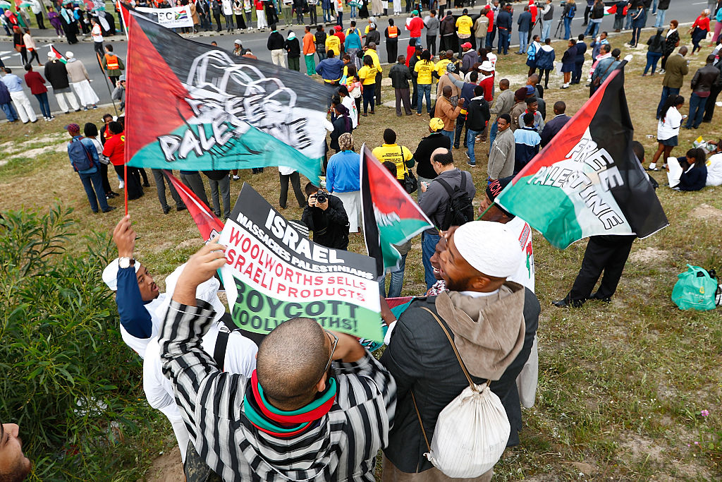 Pro-Palestinian Protestors supporting the Boycott Divestment and Sanctions (BDS) campaign against Israel, demonstrates ahead of Pharrell Williams concert outside Grand West Arena on September 21, 2015 in Cape Town, South Africa. CREDIT: Michelly Rall/Getty Images