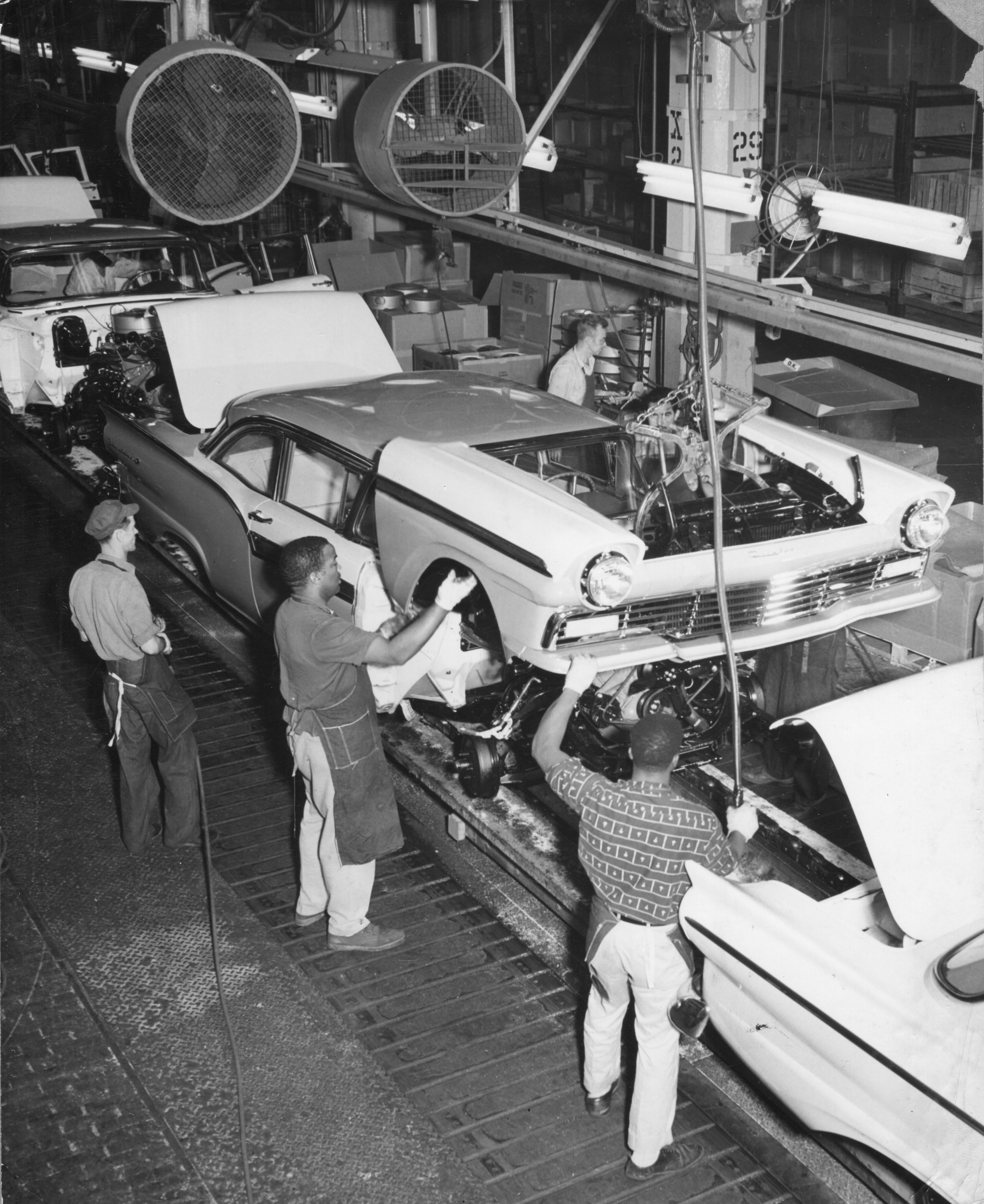 Workers on a Ford motor plant assembly line in 1961. (CREDIT: PhotoQuest/Getty Images)
