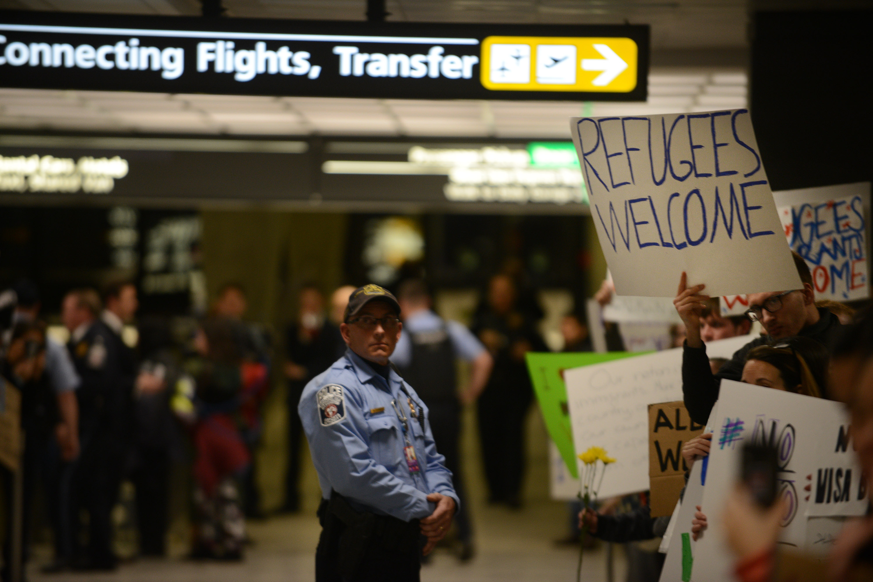 DULLES, VA - JANUARY 28: J.D. People protest and welcome arriving passengers at Dulles International Airport in Virginia, January 28, 2017. The protest follows the executive order of President Donald Trump to bar all refugees coming to the US and Muslims from seven countries. (Photo by Astrid Riecken For The Washington Post via Getty Images)