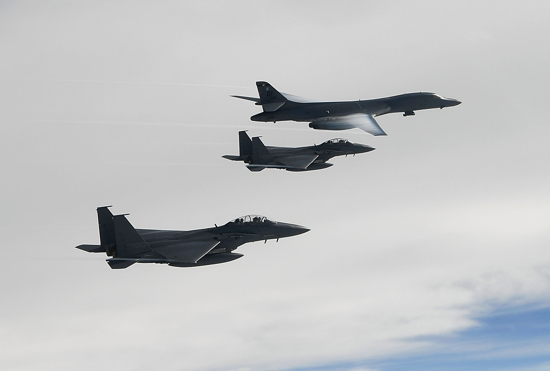 A U.S. Air Force B-1B Lancer bomber (Top) flies with South Korean jets over the Korean Peninsula during a South Korea-U.S. joint live fire drill on July 8, 2017. (CREDIT: South Korean Defense Ministry via Getty Images.)