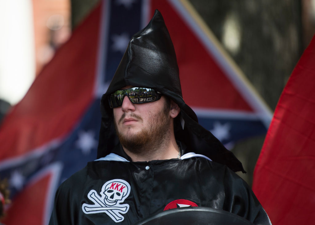 FILE PICTURE: A member of the Ku Klux Klan looks on during a rally, calling for the protection of Southern Confederate monuments, in Charlottesville, Virginia on July 8, 2017.
/ AFP PHOTO / ANDREW CABALLERO-REYNOLDS (Photo credit should read ANDREW CABALLERO-REYNOLDS/AFP/Getty Images)