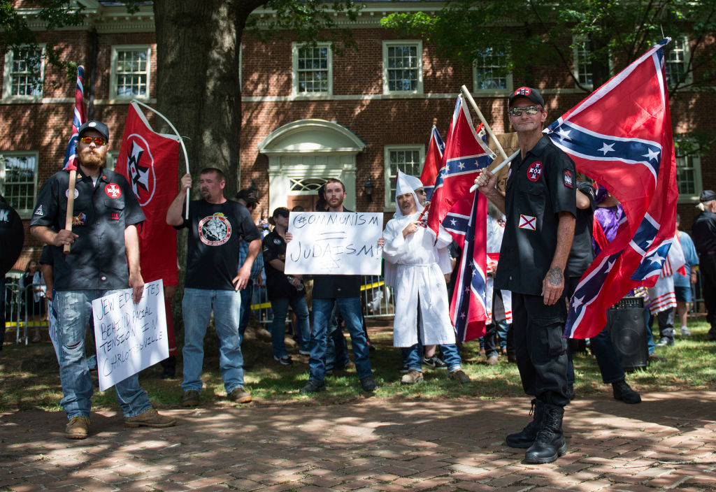 Members of the Ku Klux Klan look on during a rally (CREDIT: ANDREW CABALLERO-REYNOLDS/AFP/Getty Images)