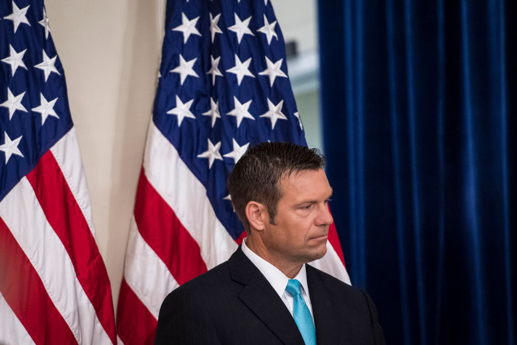 Kansas Secretary of State Kris Kobach listens as Vice President Mike Pence speaks at the first meeting of the Presidential Advisory Commission on Election Integrity on Wednesday, July 19, 2017. (CREDIT: Jabin Botsford/The Washington Post via Getty Images)