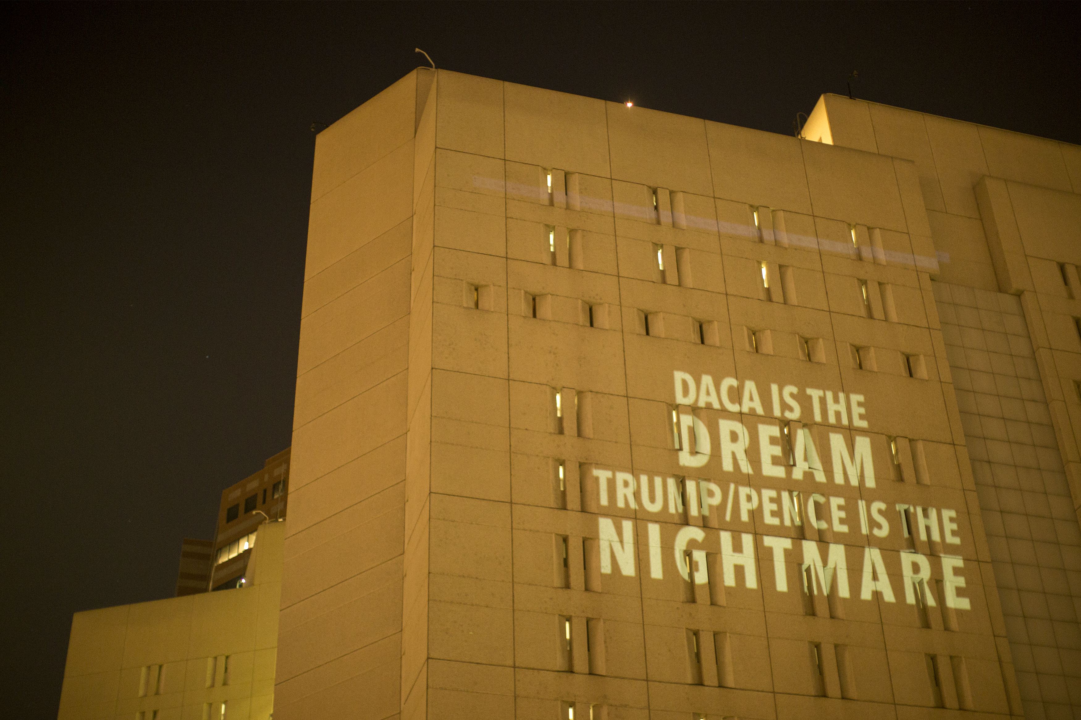 LOS ANGELES, CA - SEPTEMBER 05: Activists from RefuseFascism.org project anti-Trump administration messages onto the side of the Metropolitan Detention Center, where many undocumented people are jailed, in a seven city action after President Trump ordered an end to DACA on September 5, 2017 in Los Angeles, United States. (Photo by David McNew/Getty Images)