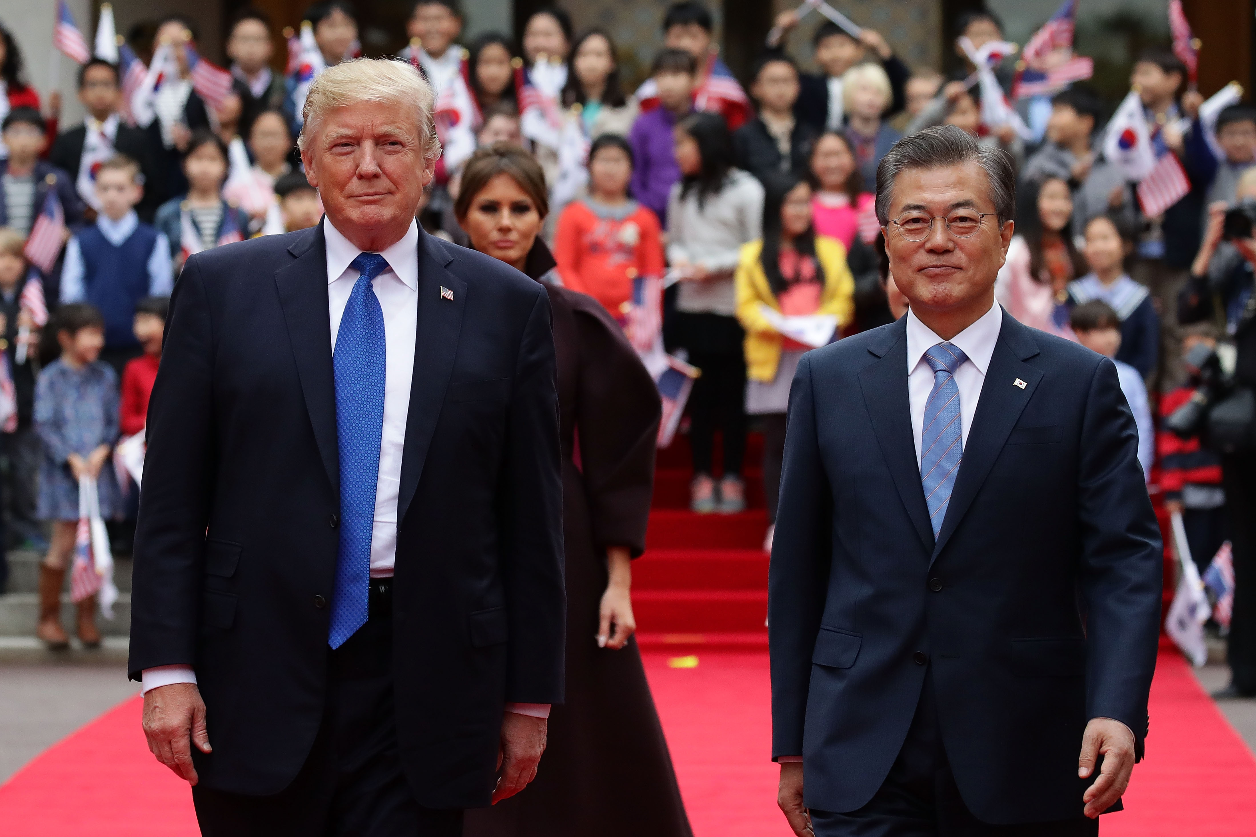 South Korean President Moon Jae-In and President Donald Trump walk towards a guard of honor during a welcoming ceremony at the presidential Blue House on November 7, 2017 in Seoul, South Korea. Trump is in South Korea as a part of his Asian tour. CREDIT: Chung Sung-Jun/Getty Images