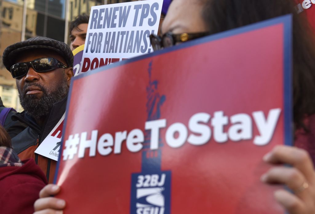 Immigrant advocates rally against the Trump administration's decision to terminate temporary protected status for Haitians in November 2017. CREDIT: TIMOTHY A. CLARY/AFP/Getty Images