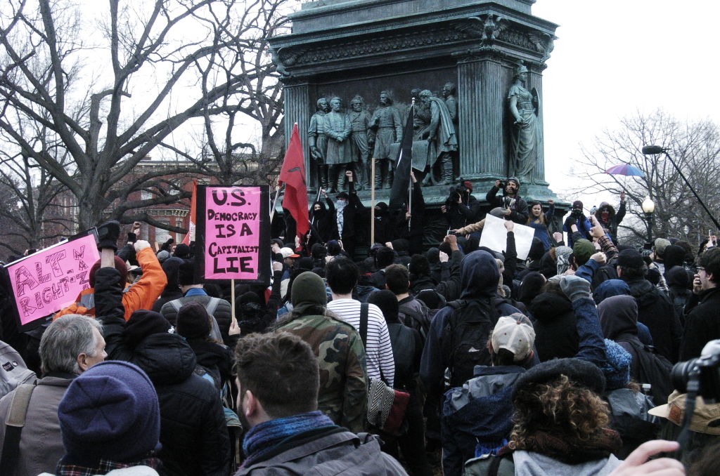 Protesters gather in a park at the onset of protests against the inauguration of Donald Trump in Washington DC on January 20, 2017. CREDIT: NurPhoto/Getty Images