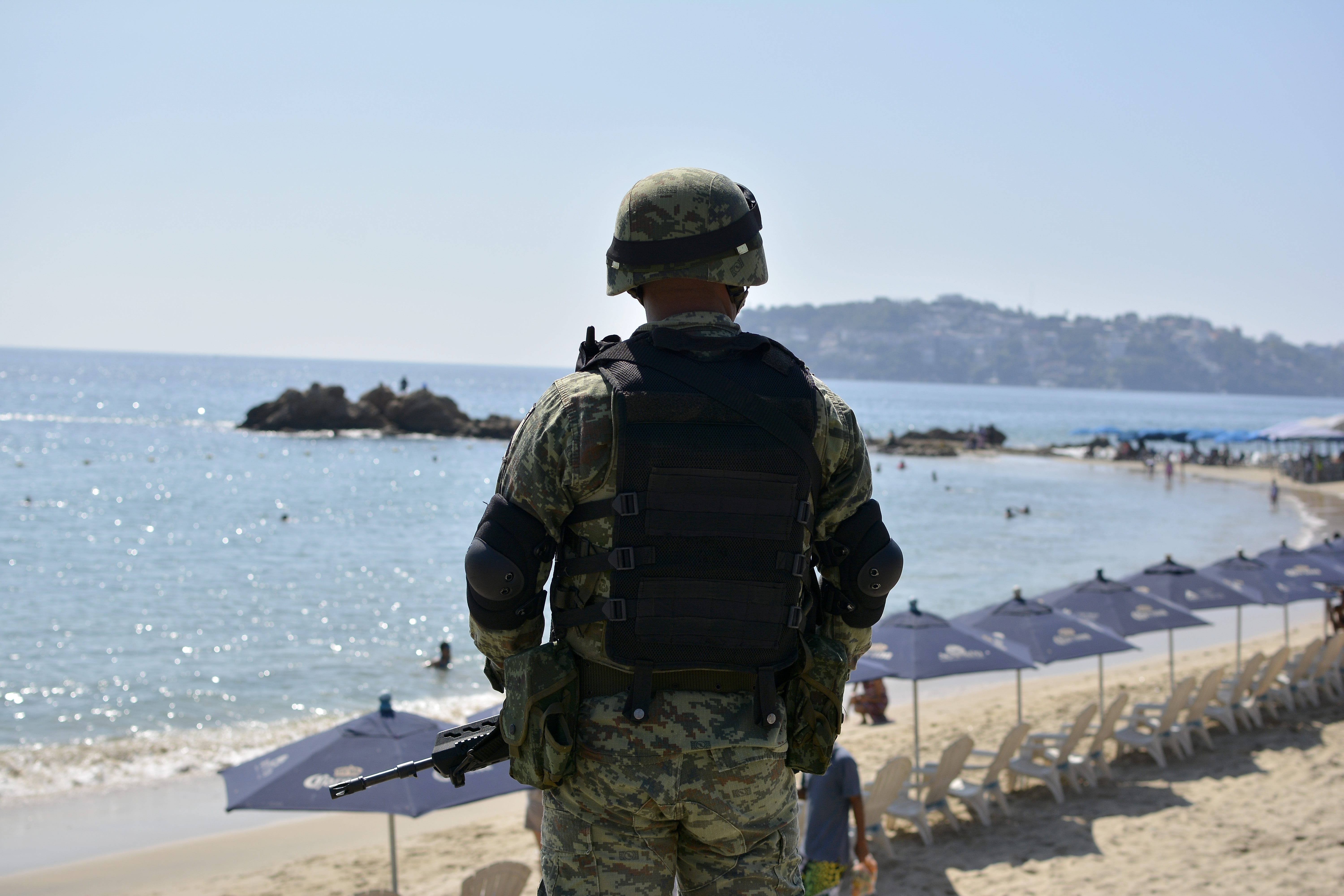 A Mexican Army soldier stands guard at a beach in Acapulco, Guerrero state, Mexico on December 5, 2017.
/ AFP PHOTO / FRANCISCO ROBLES (Photo credit should read FRANCISCO ROBLES/AFP/Getty Images)