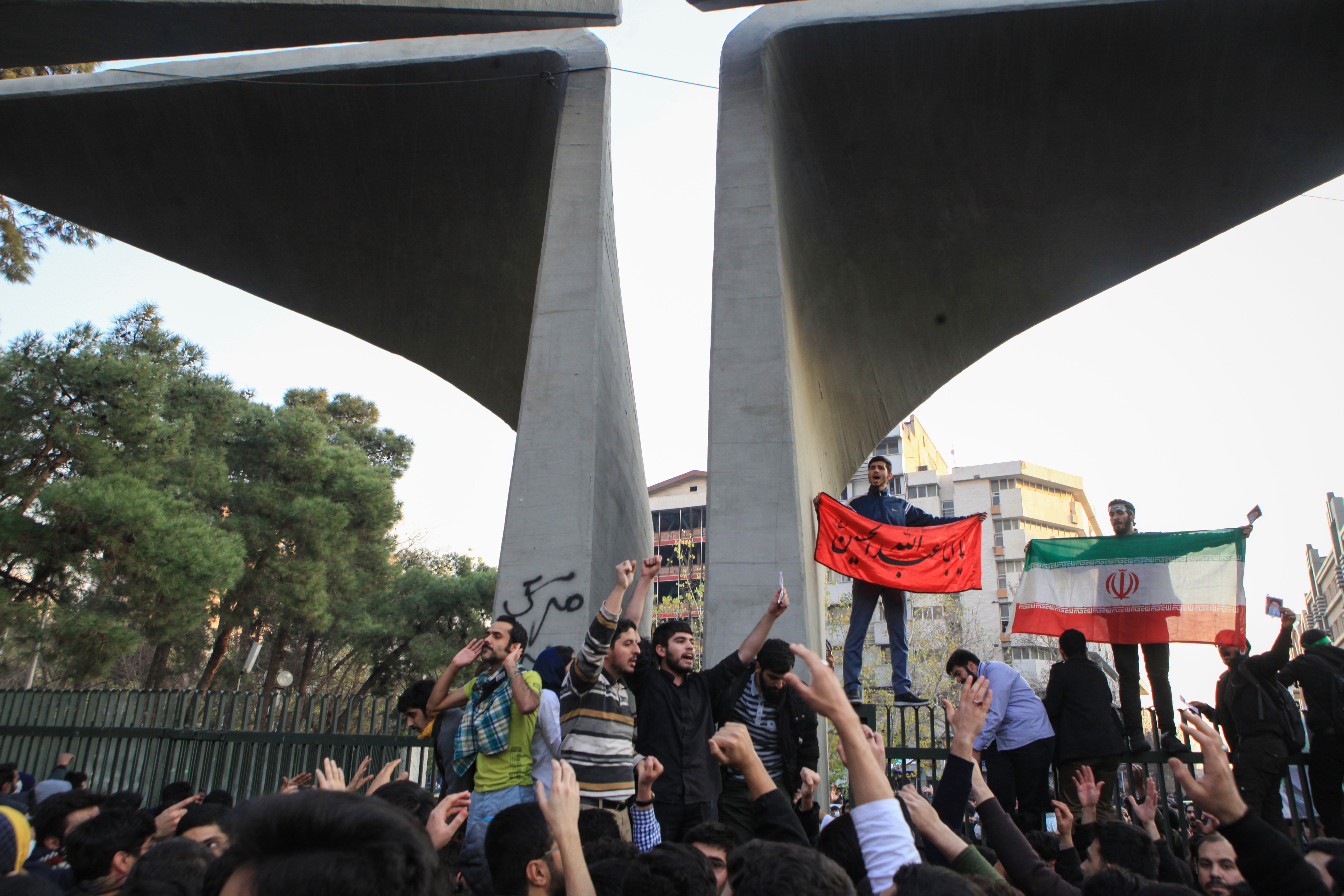 People gather to protest over high cost of living in Tehran, Iran on December 30, 2017. CREDIT: Anadolu Agency via Getty Images.
