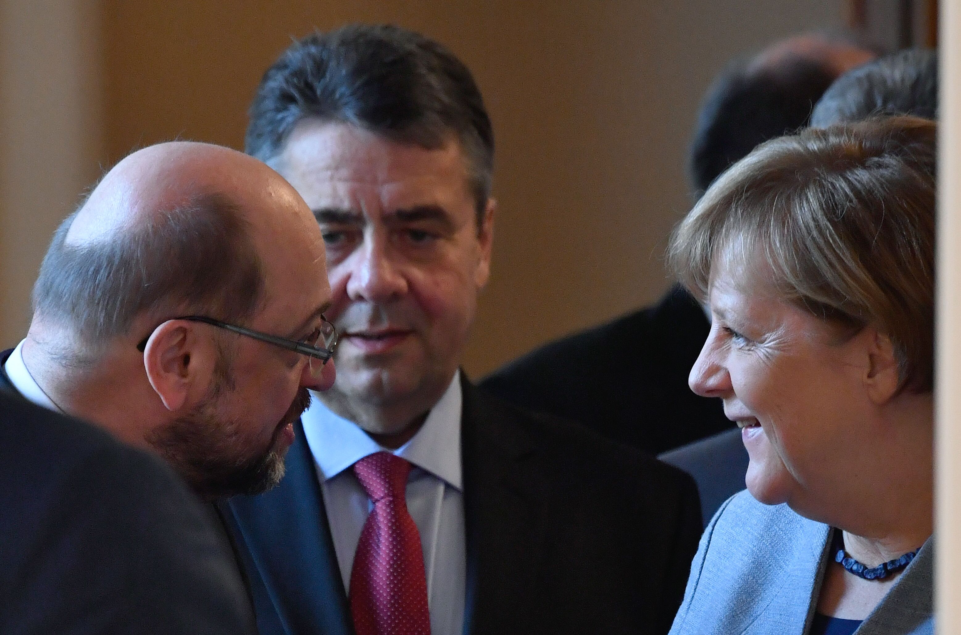 The leader of Germany's social democratic SPD party Martin Schulz (L), German Vice Chancellor and Foreign Minister Sigmar Gabriel (C) and German Chancellor Angela Merkel talk as they wait to be introduced to the German President during a New Year's reception at the presidential Bellevue Palace in Berlin on January 9, 2018. (CREDIT: John Macdougall/AFP Photos/Getty Images)