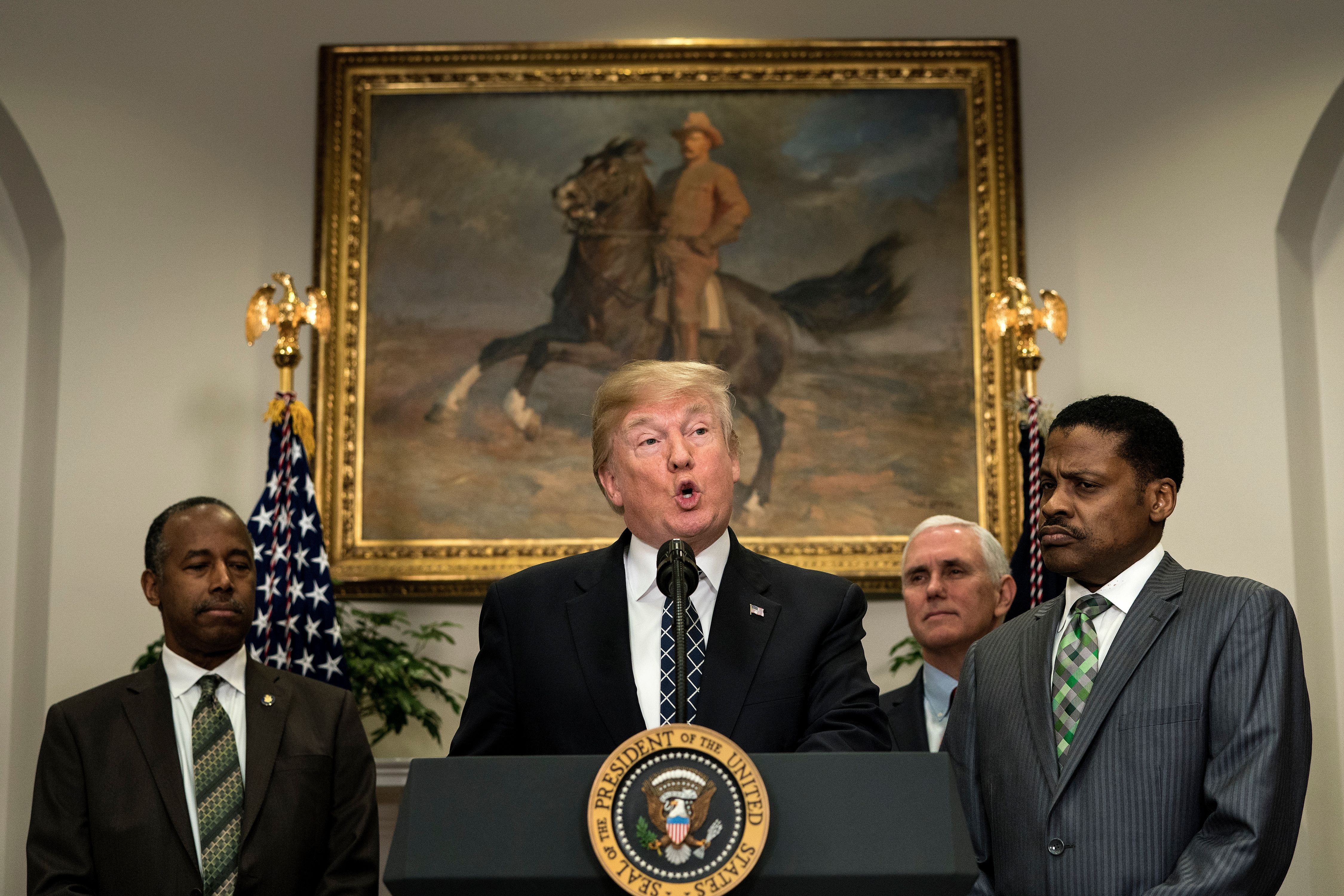 Secretary of Housing and Urban Development Ben Carson, Vice President Mike Pence, and Isaac Newton Farris Jr. listen while President Donald Trump speaks during an event about Martin Luther King Jr. (CREDIT: BRENDAN SMIALOWSKI/AFP/Getty Images)