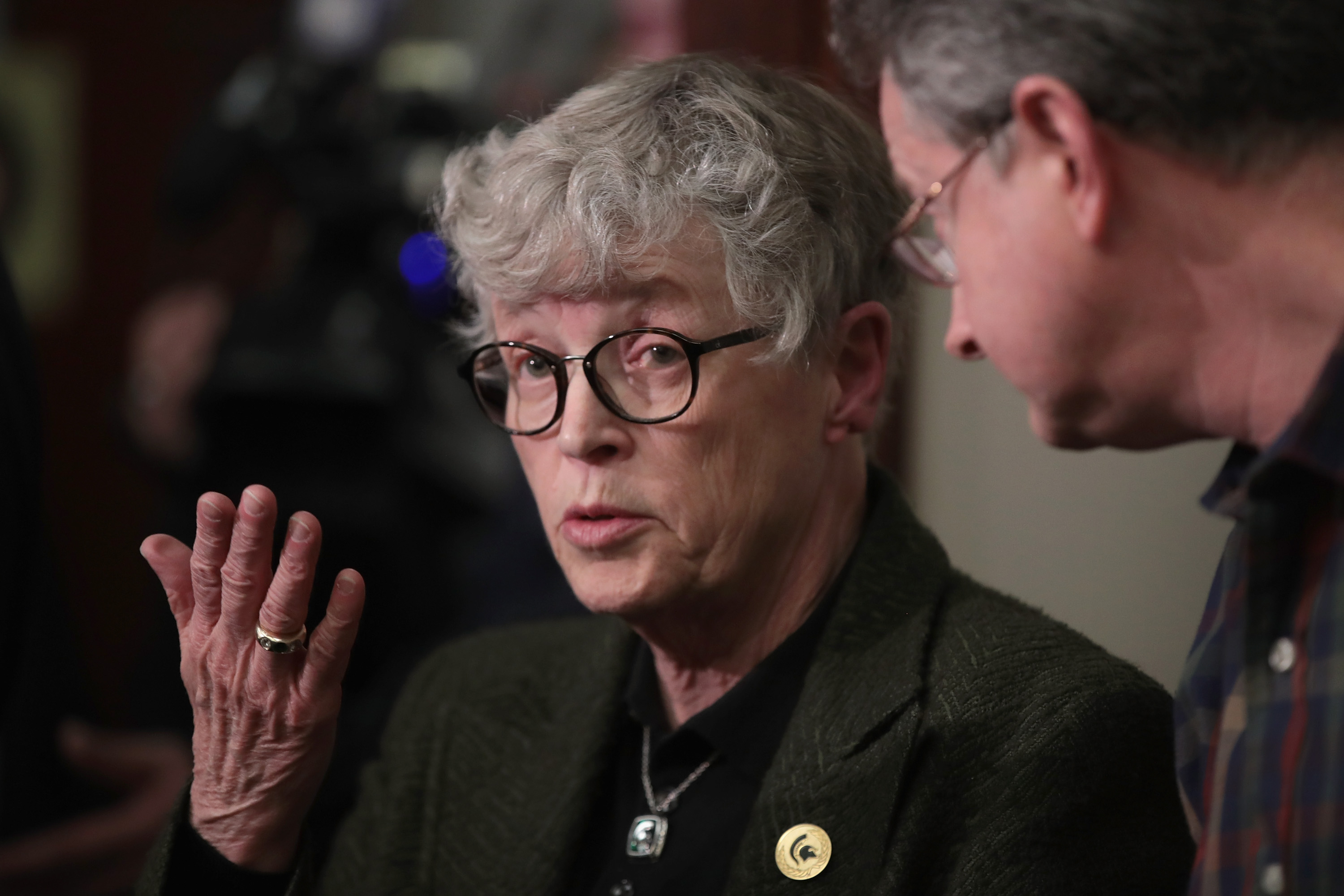 Michigan State University (MSU) President Lou Anna Simon answers a question after being confronted by former MSU gymnast Lidsey Lemke during a break in the sentencing hearing for Larry Nassar. Photo by Scott Olson/Getty Images